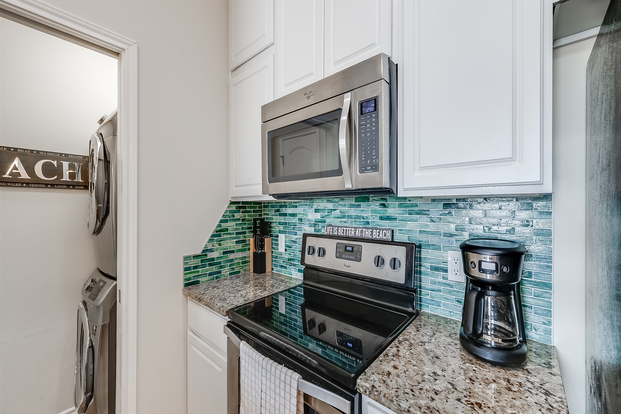The kitchen features a 3-person bar seating, custom cabinets, granite countertops, beautiful designer backsplash, and stainless steel appliances. Coupled with the attached dining room, it is the perfect place for intimate gatherings.