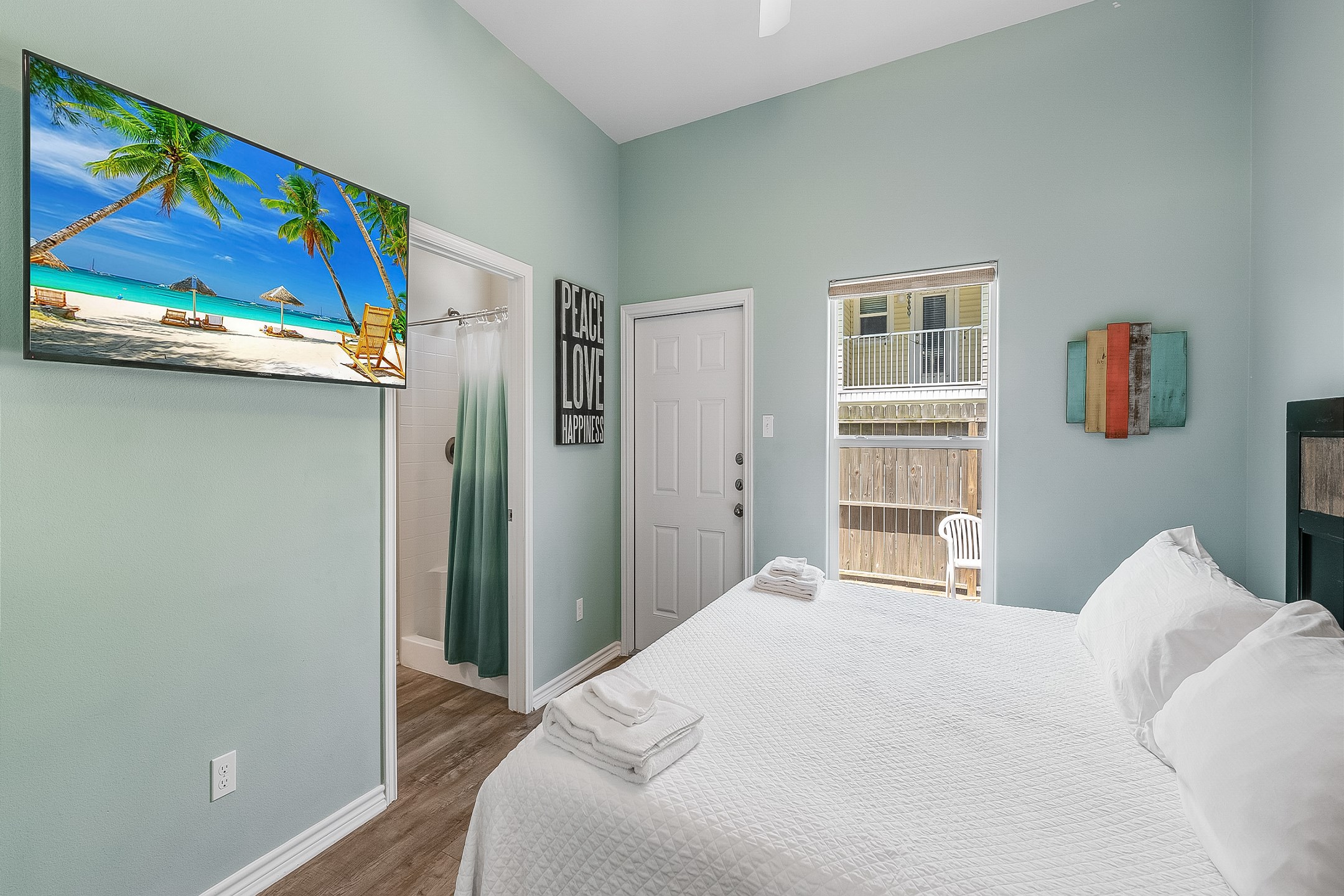Master bedroom on the first floor with king size bed, flat screen TV, and private bathroom