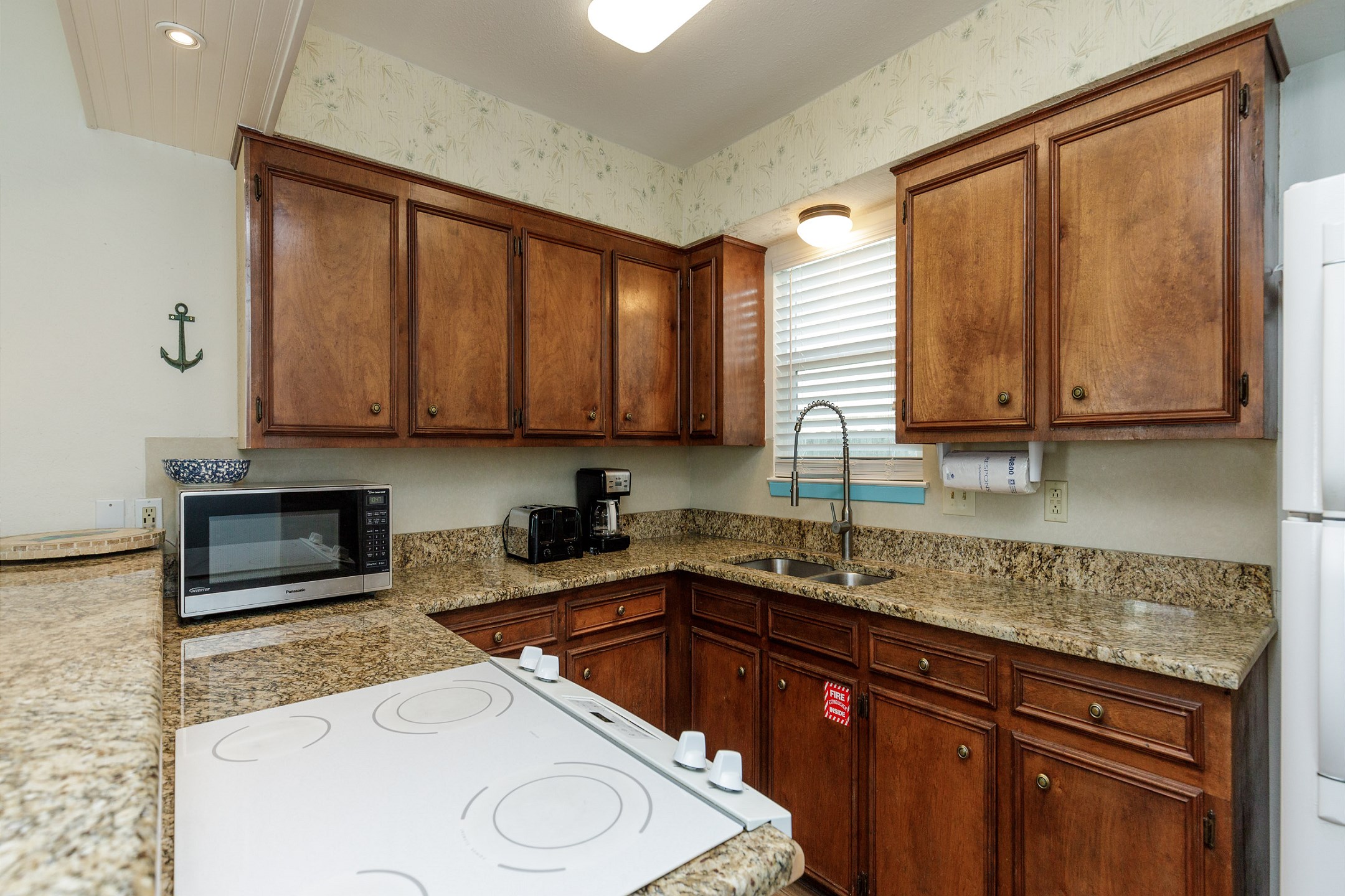 Fully equipped kitchen area with coffee maker, toaster, and other essentials provided