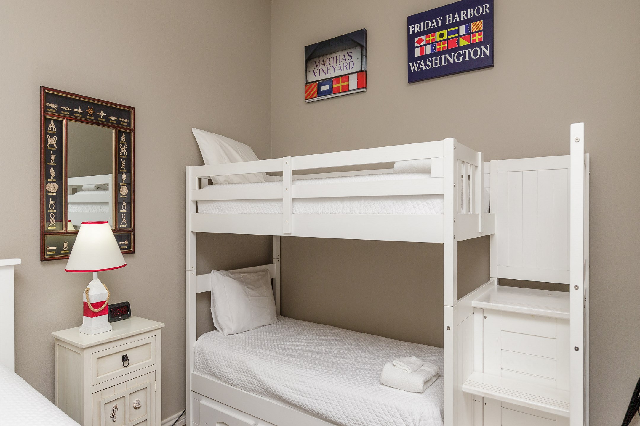 Second bedroom with queen size bed, twin bunk beds, and an arcade game 