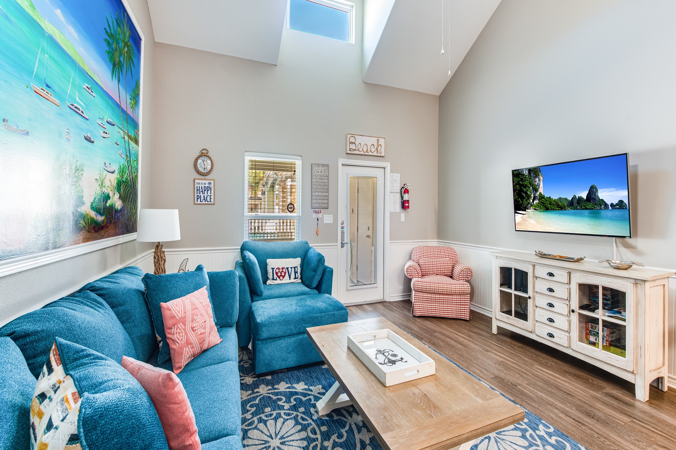 Cozy living area with new furniture, high ceilings and flat screen TV 