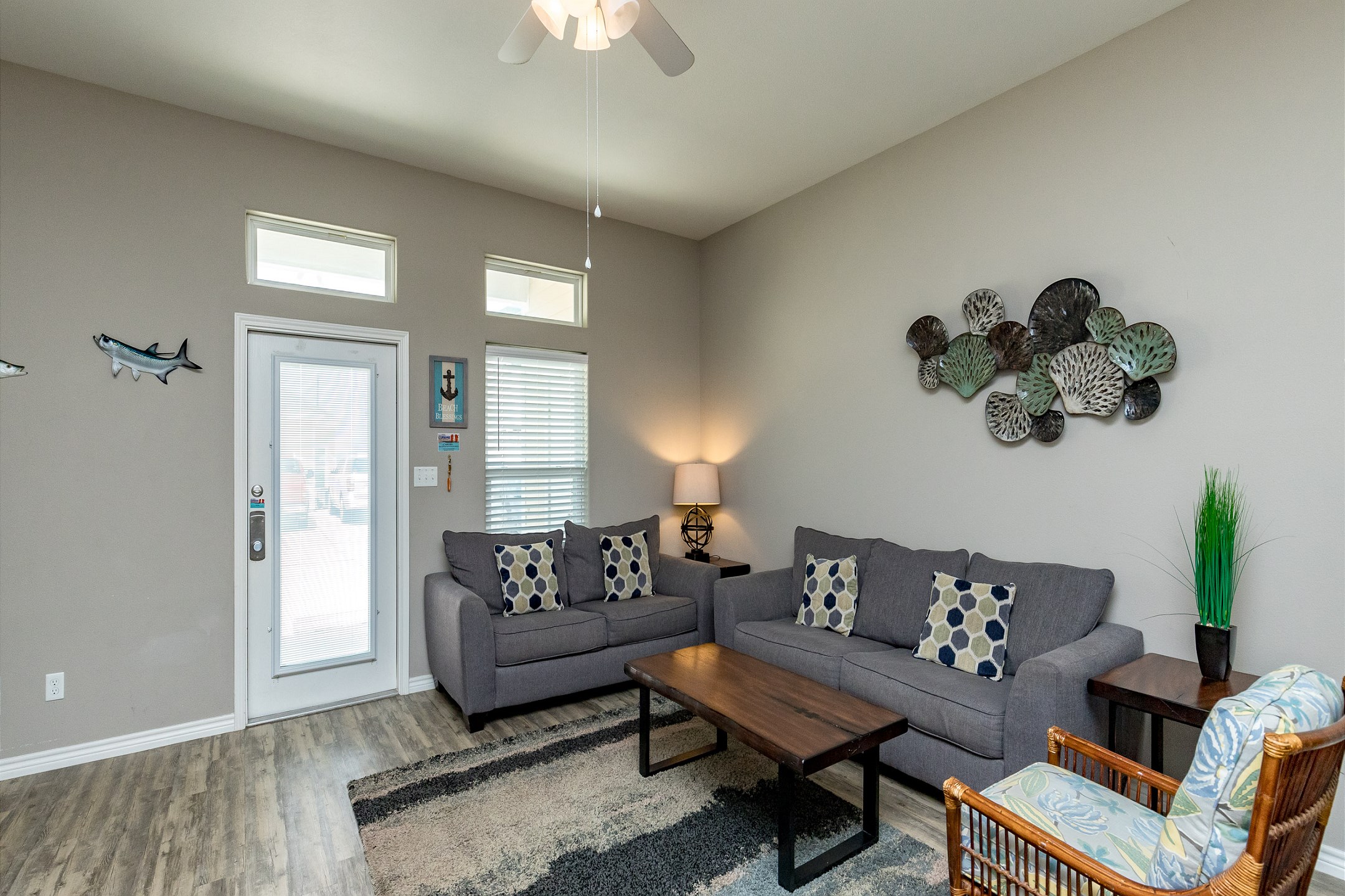Living area with queen size sleeper sofa and coastal features throughout