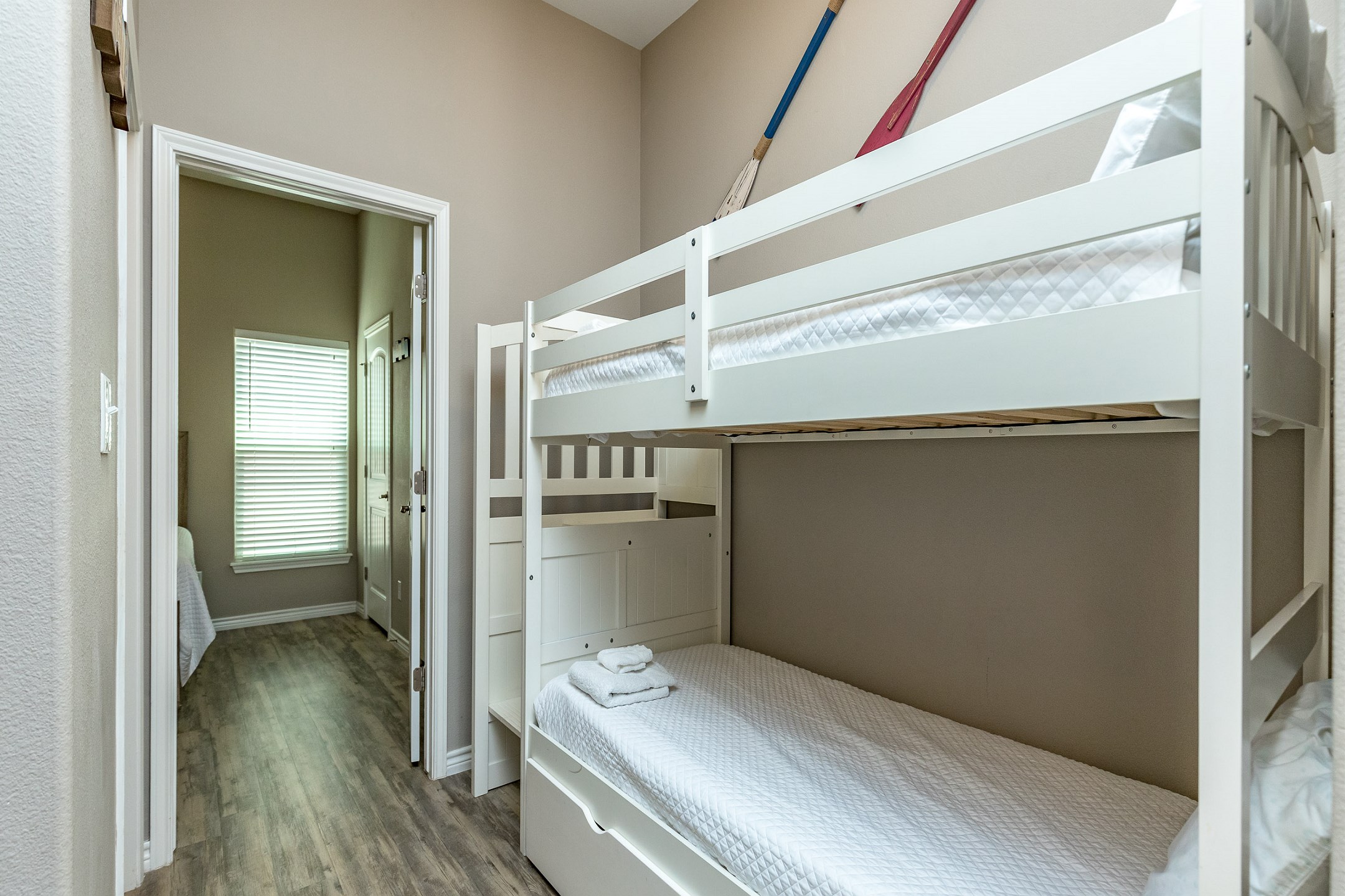 Twin bunk beds in hallway off kitchen area
