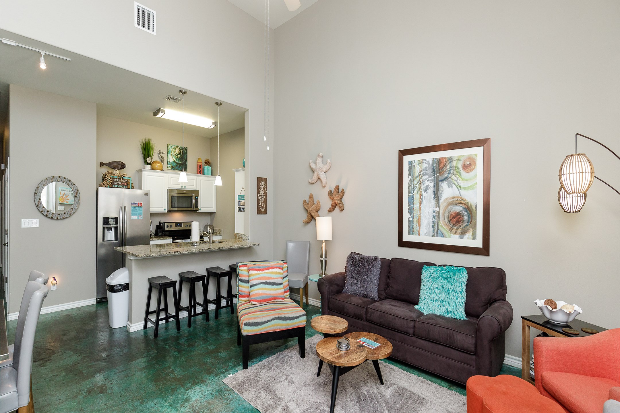 Open-concept living area with high ceilings, flooded with natural light 