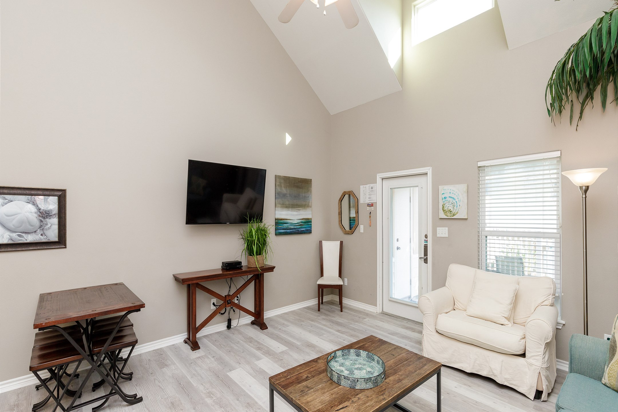 Living and dining area with comfy furniture and new flooring throughout 