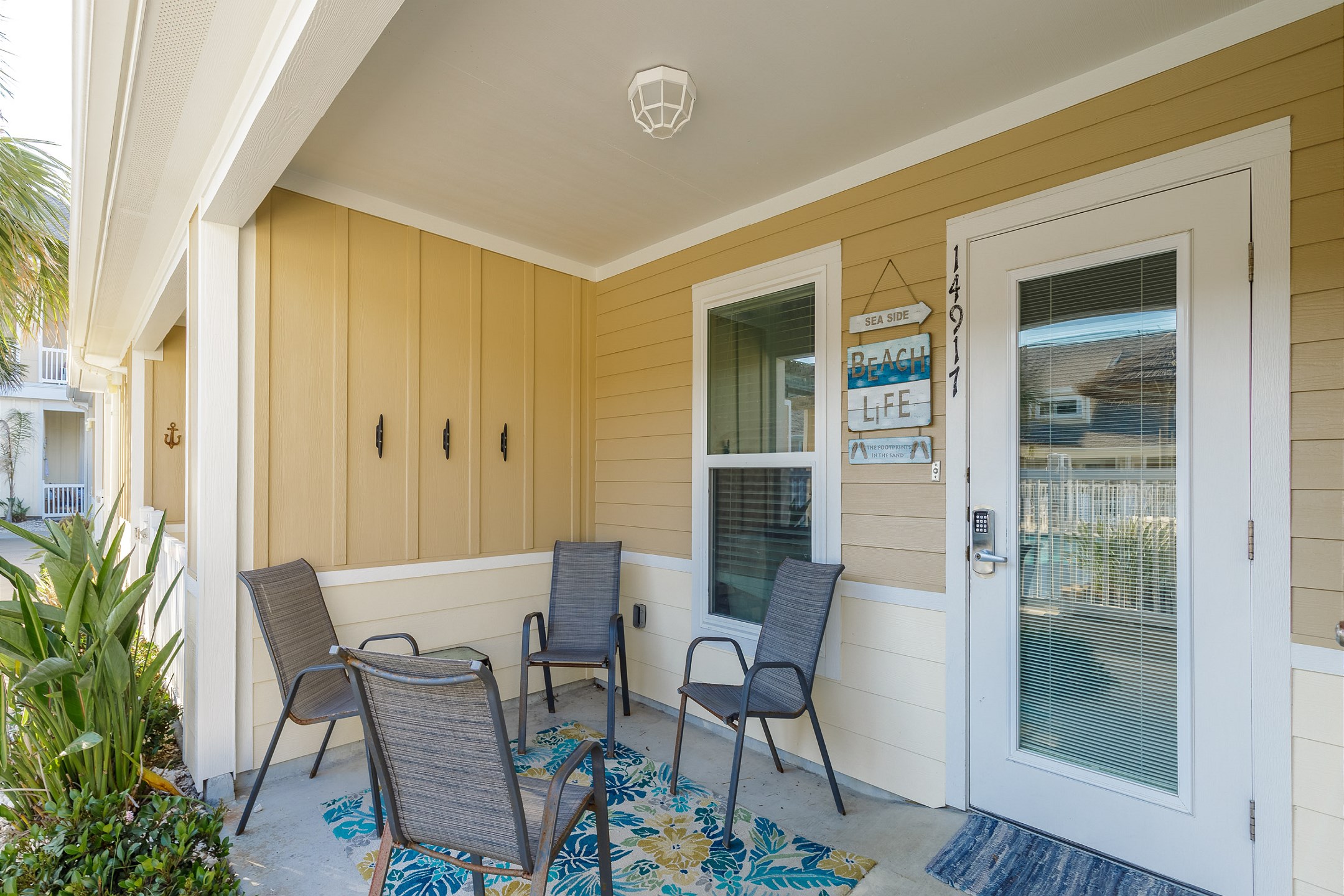 Lovely patio area with cozy seating and main entrance 