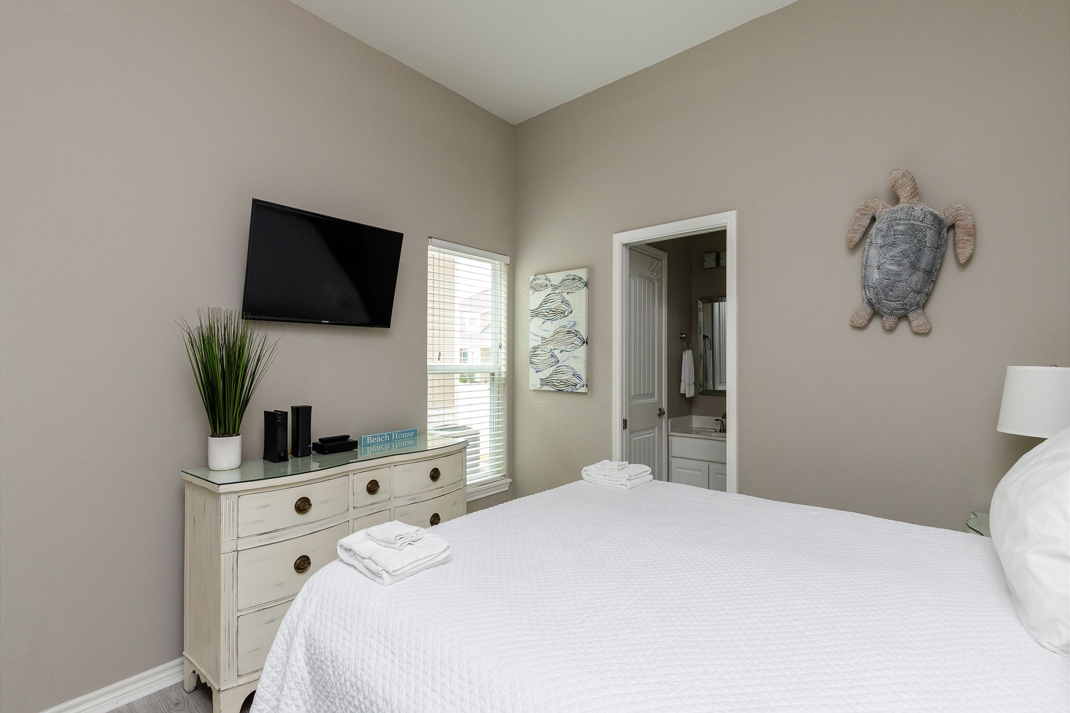 Master bedroom with king size bed, private bathroom and flat screen TV