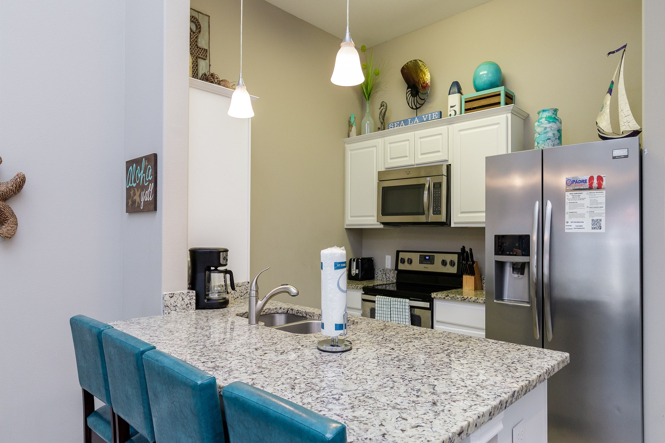 Fully equipped kitchen with stainless steel appliances and breakfast bar for four 