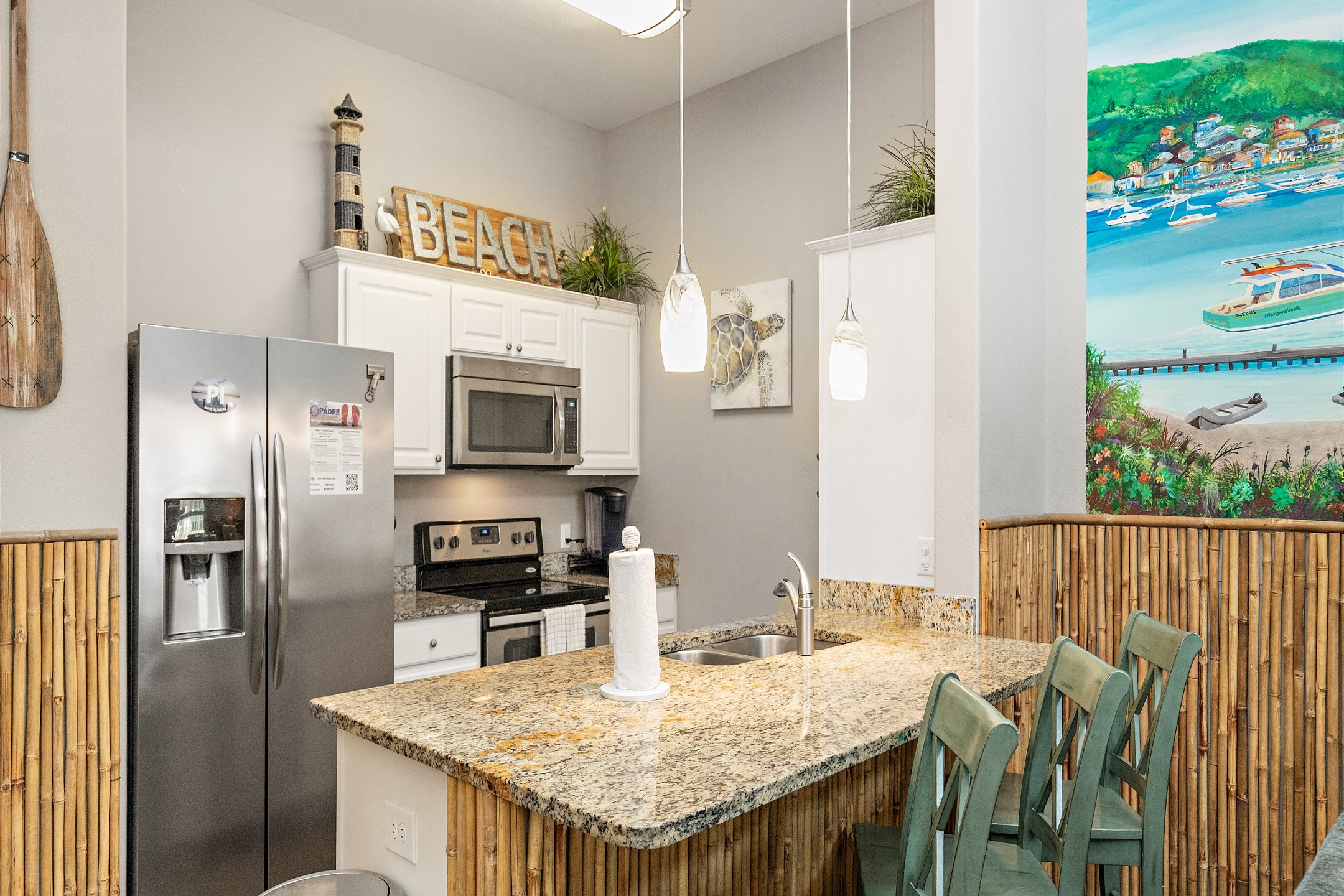 Fully equipped kitchen with breakfast bar that seats three