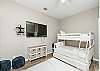 Second bedroom with queen size bed and twin bed over full size bunk bed with twin trundle 
