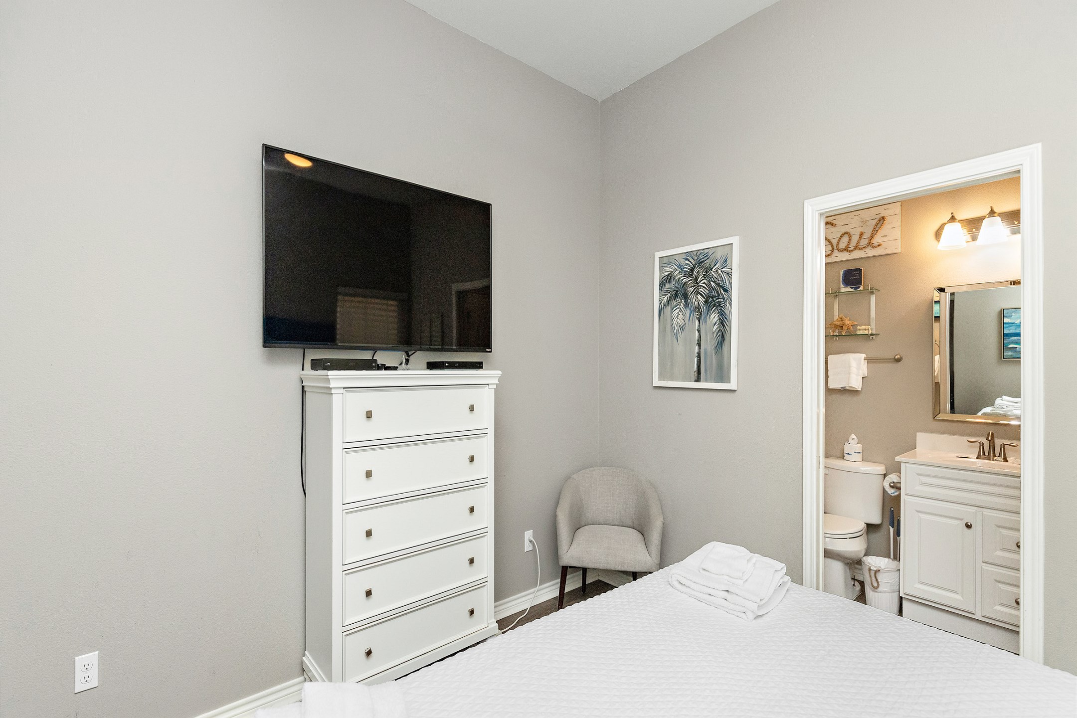 Master bedroom with king size bed, private bathroom and flat screen TV
