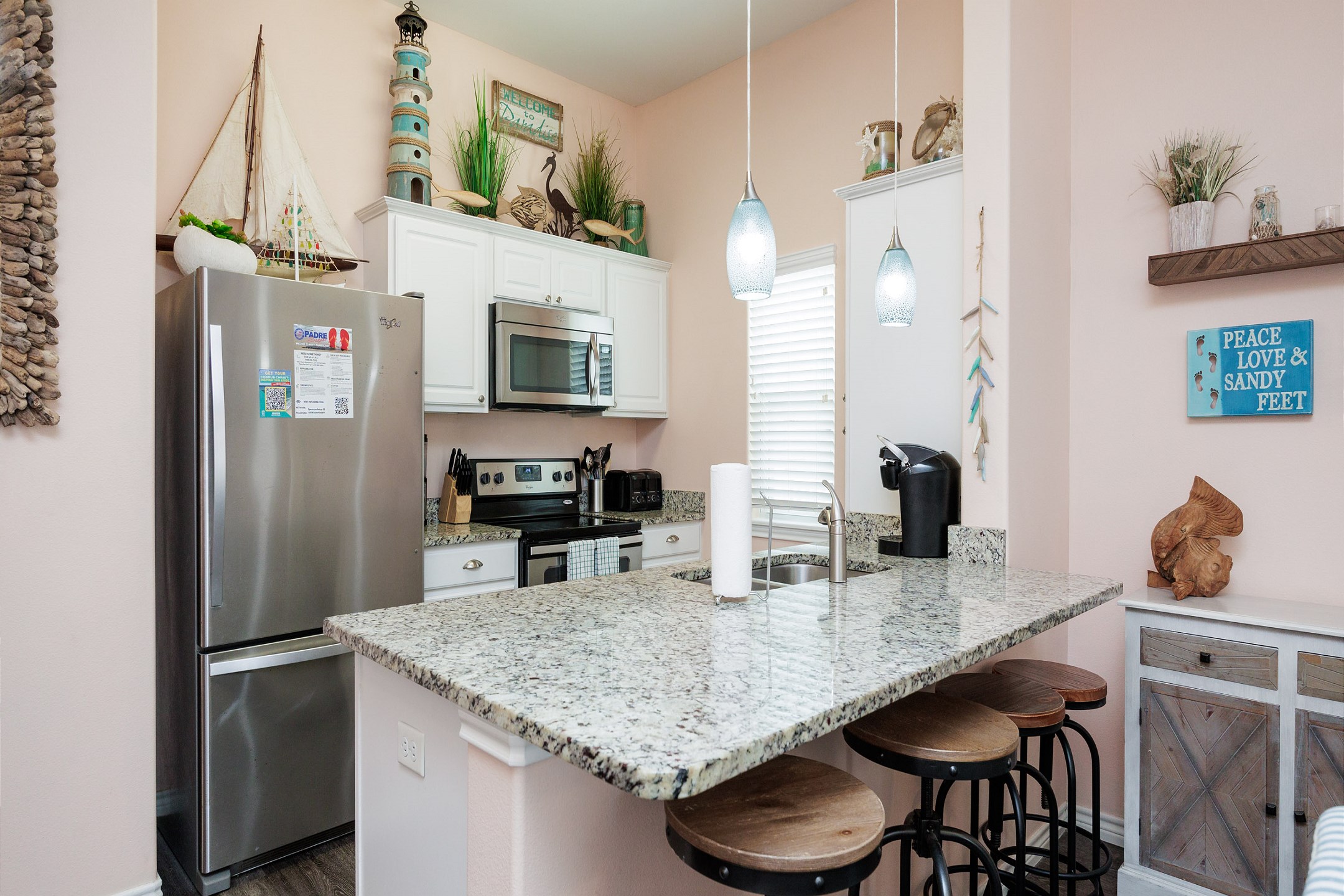 Beautiful kitchen area with island breakfast bar for casual dining