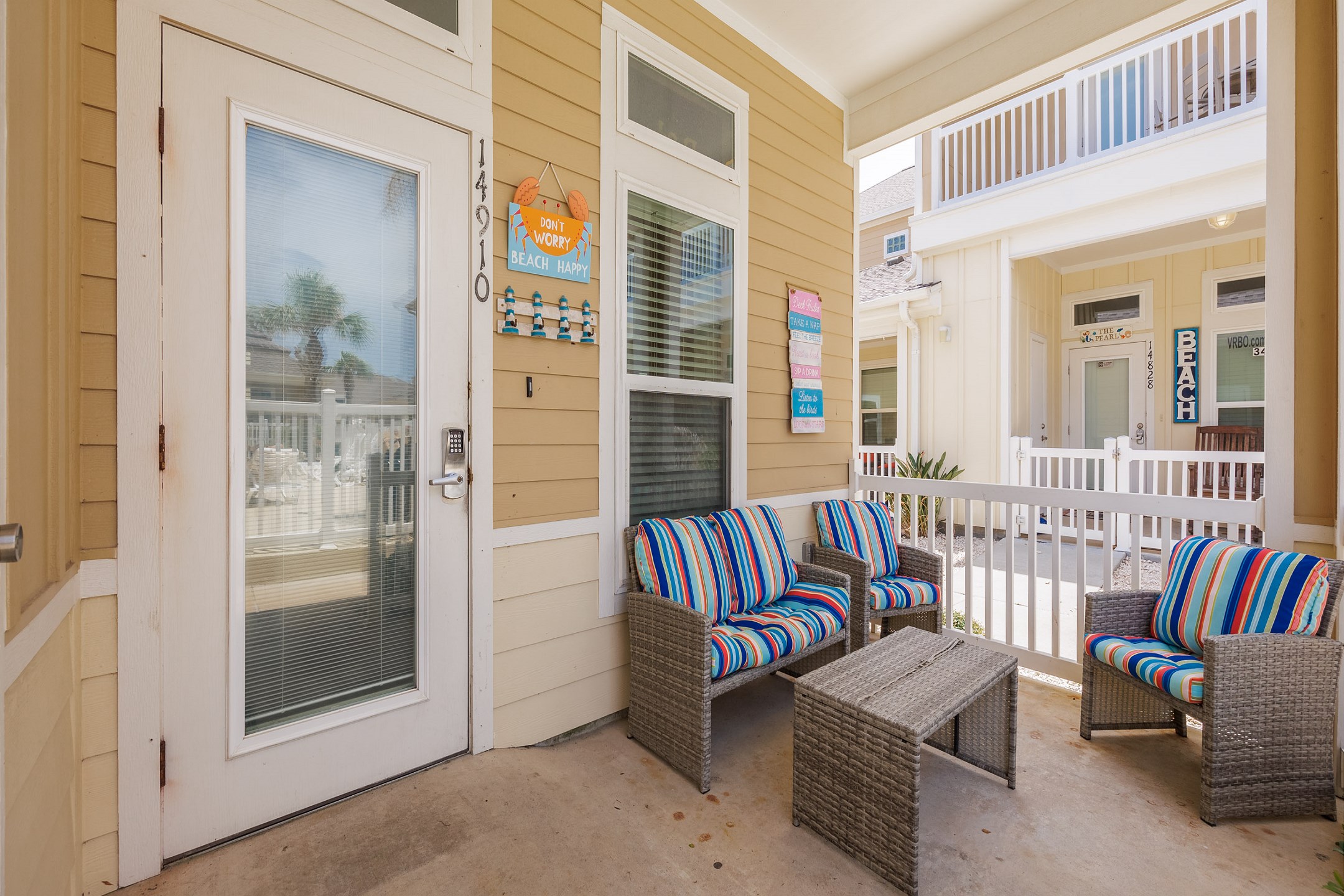 Front patio entrance with comfortable seating, directly across from the pool