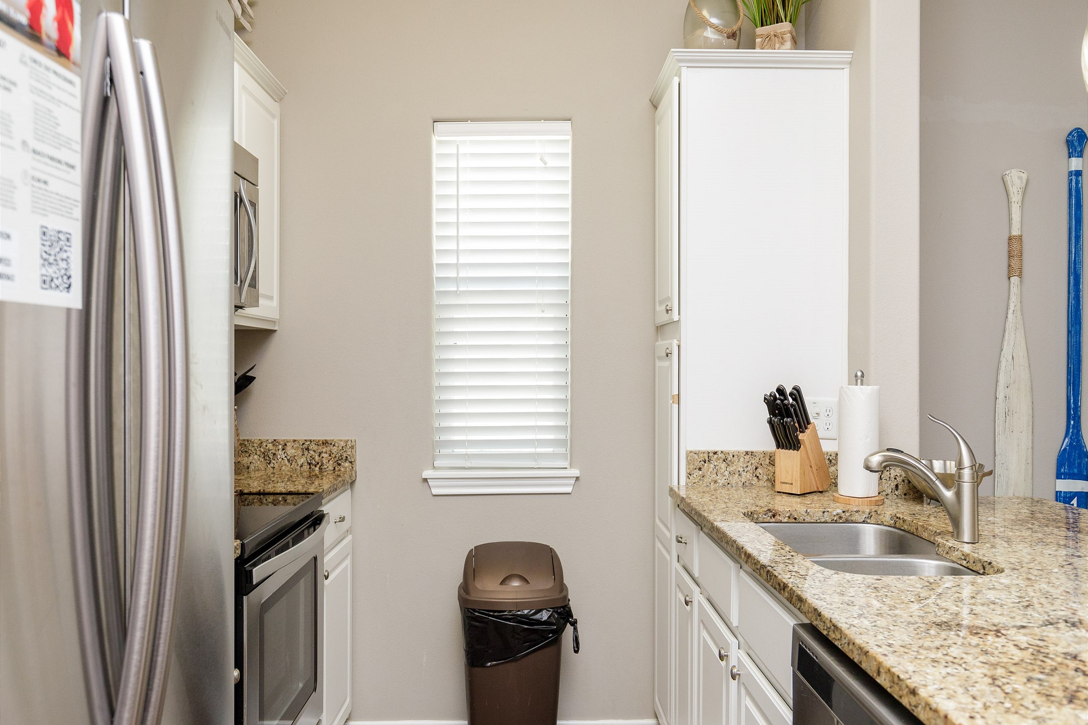 Great kitchen space with cookware, utensils, and dinnerware for guest use