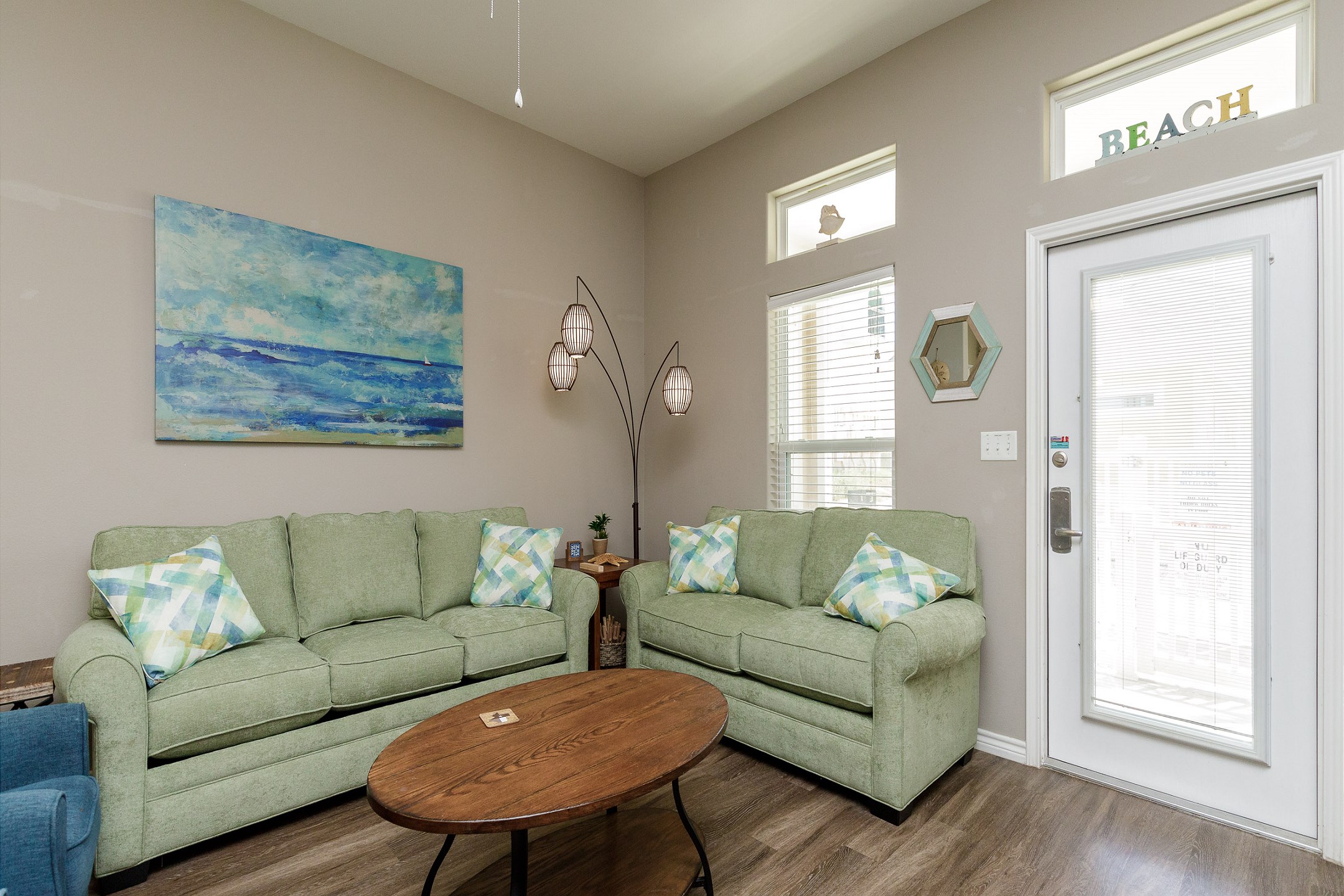 Bright living area with queen size sleeper sofa and coastal vibes