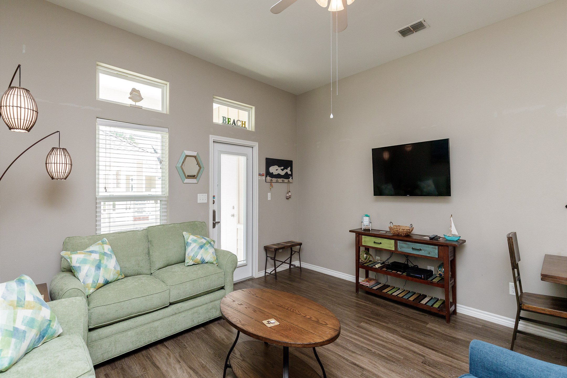 Spacious living area with comfy furnishings and flat screen TV