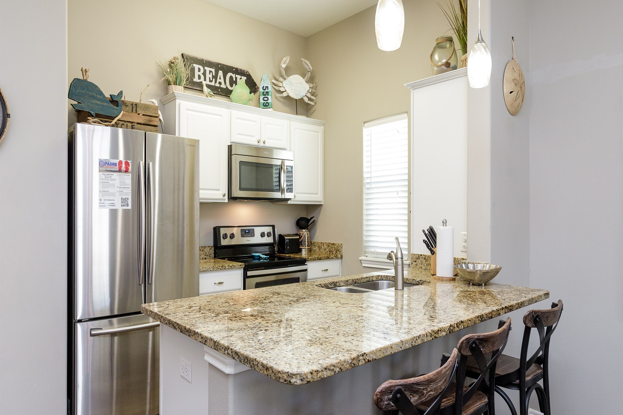 Fully equipped kitchen area with breakfast bar that seats three