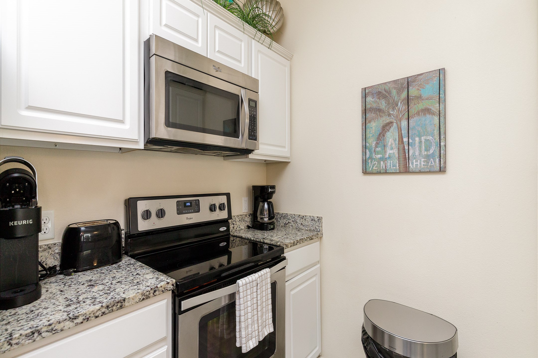 Fully equipped kitchen with stainless steel appliances, along with Keurig and 12-cup coffee maker 