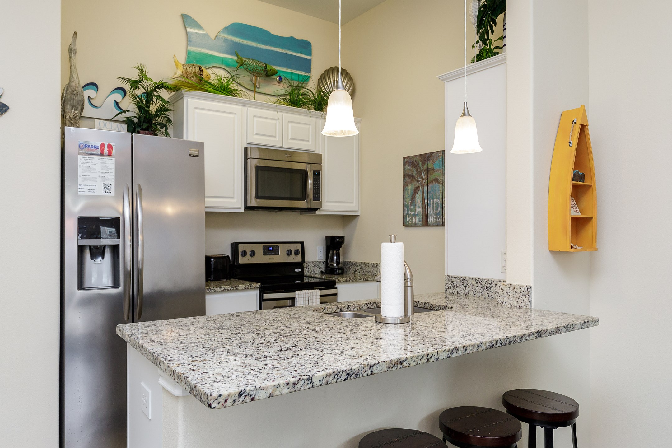 Fully equipped kitchen area with breakfast bar that seats four