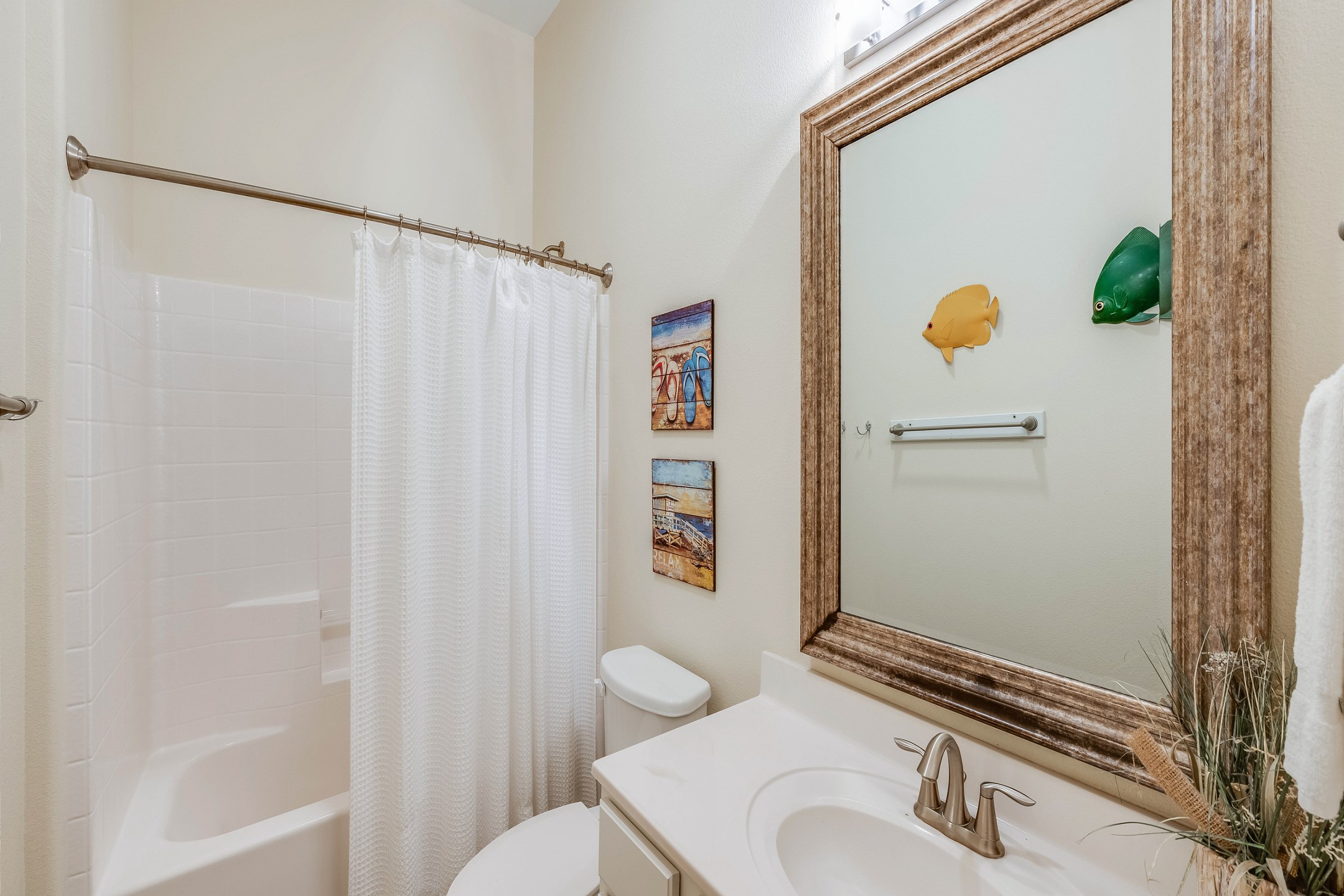 Guest bathroom includes a tub and shower combination