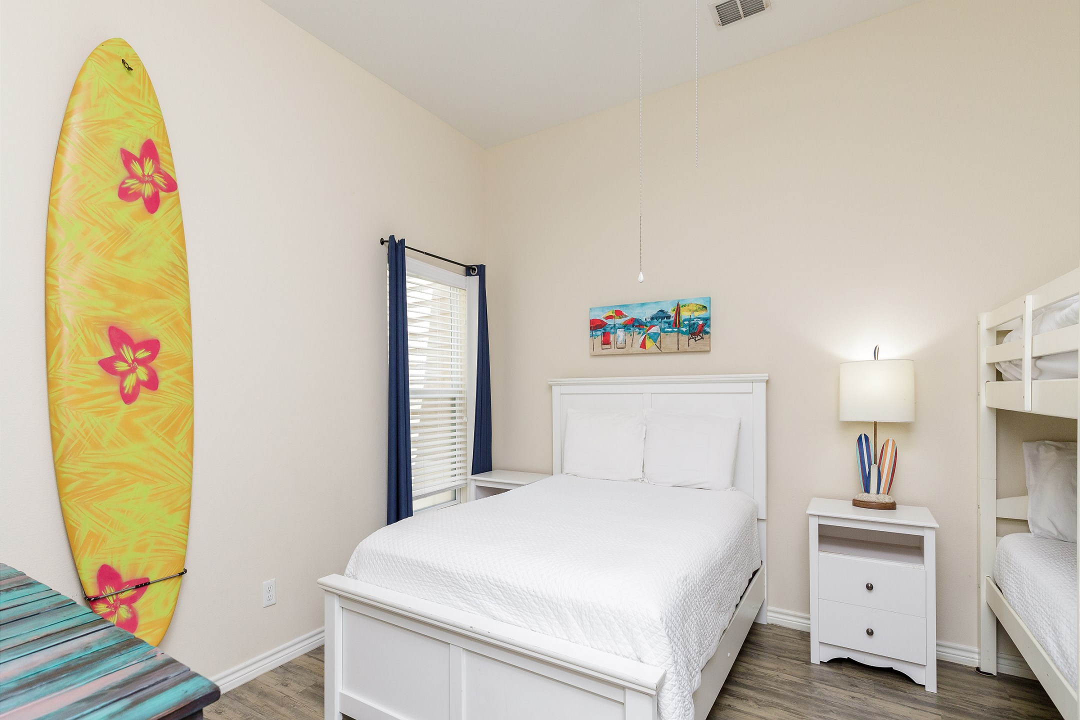 Second bedroom with queen size bed and twin size bunk beds, along with Apple TV