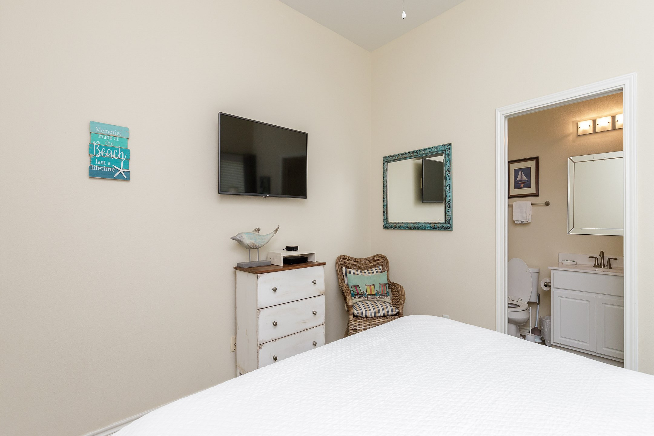 Master bedroom with king size bed, private bathroom, and Apple TV