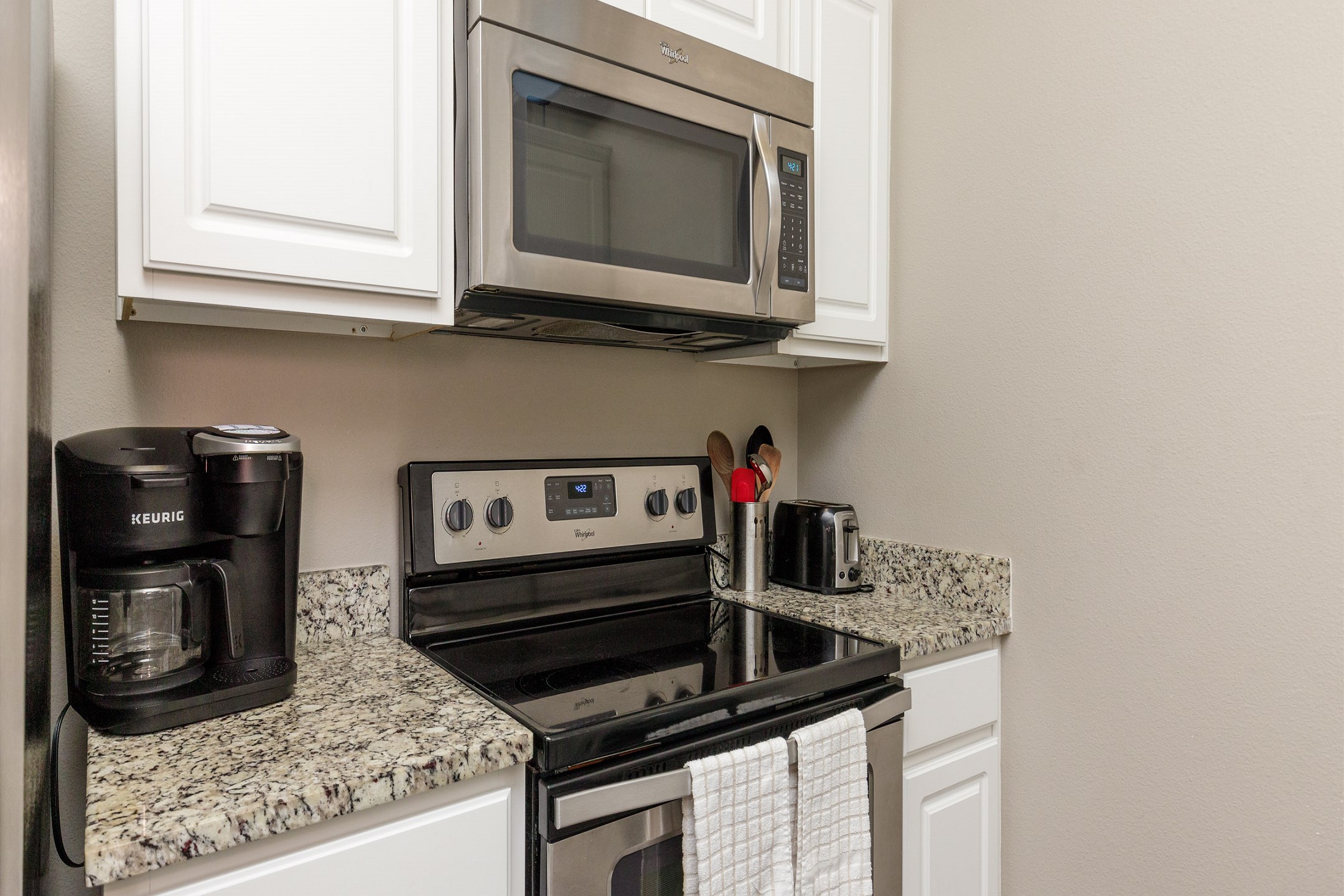 Kitchen space with coffee maker, toaster, cookware, dinnerware, and other kitchen essentials provided