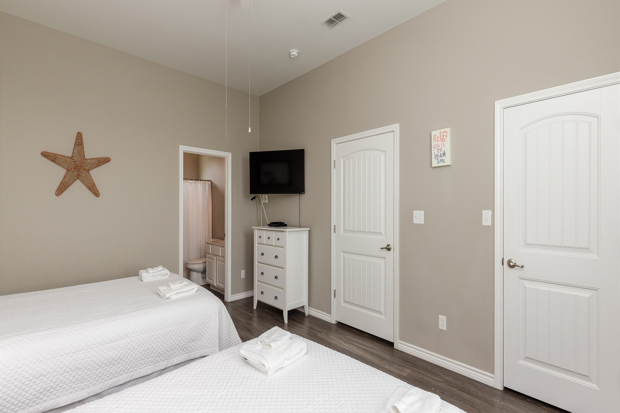 Second bedroom on the second floor with two queen size beds, private bathroom, and flat screen TV