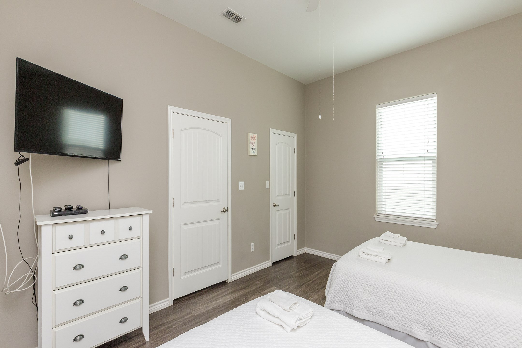 Second bedroom on the second floor with two queen size beds, private bathroom, and flat screen TV