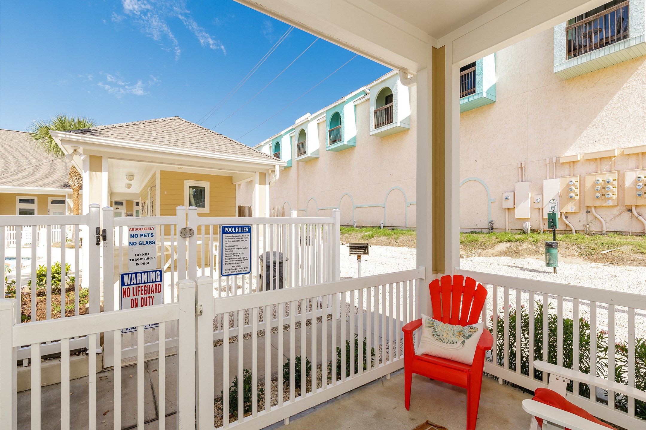 Private patio with comfy seating and a view of the pool 