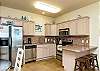 Fully equipped kitchen with plenty of storage and breakfast bar that seats three