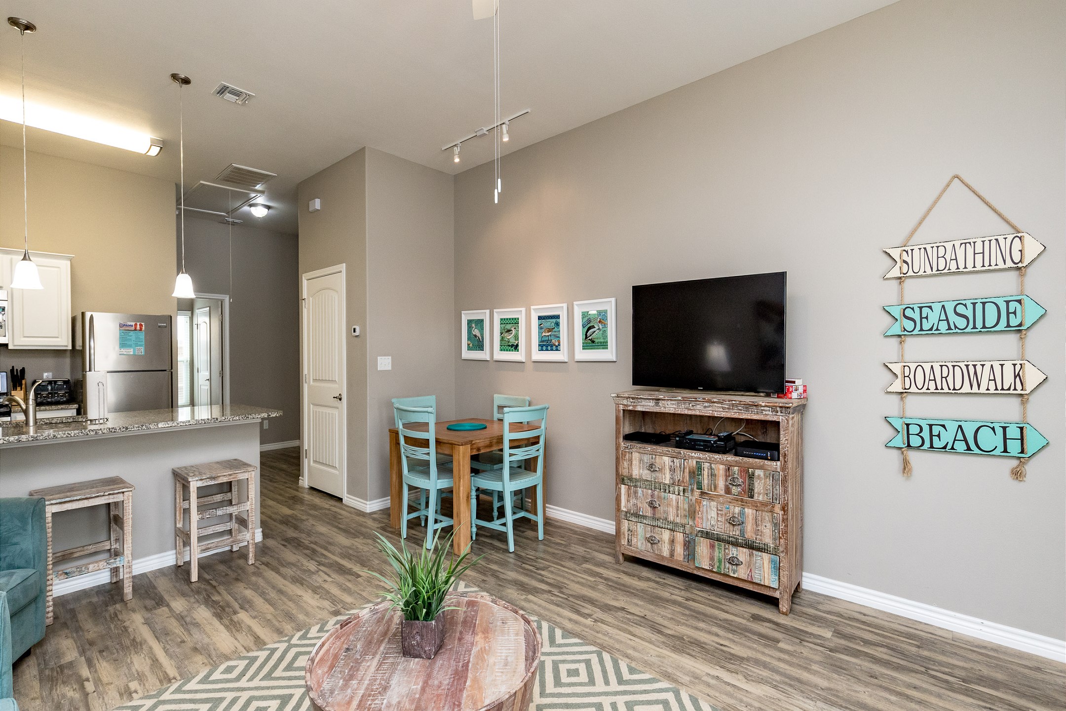 The kitchen, dining, and living areas blend together seamlessly for a bright and airy feel