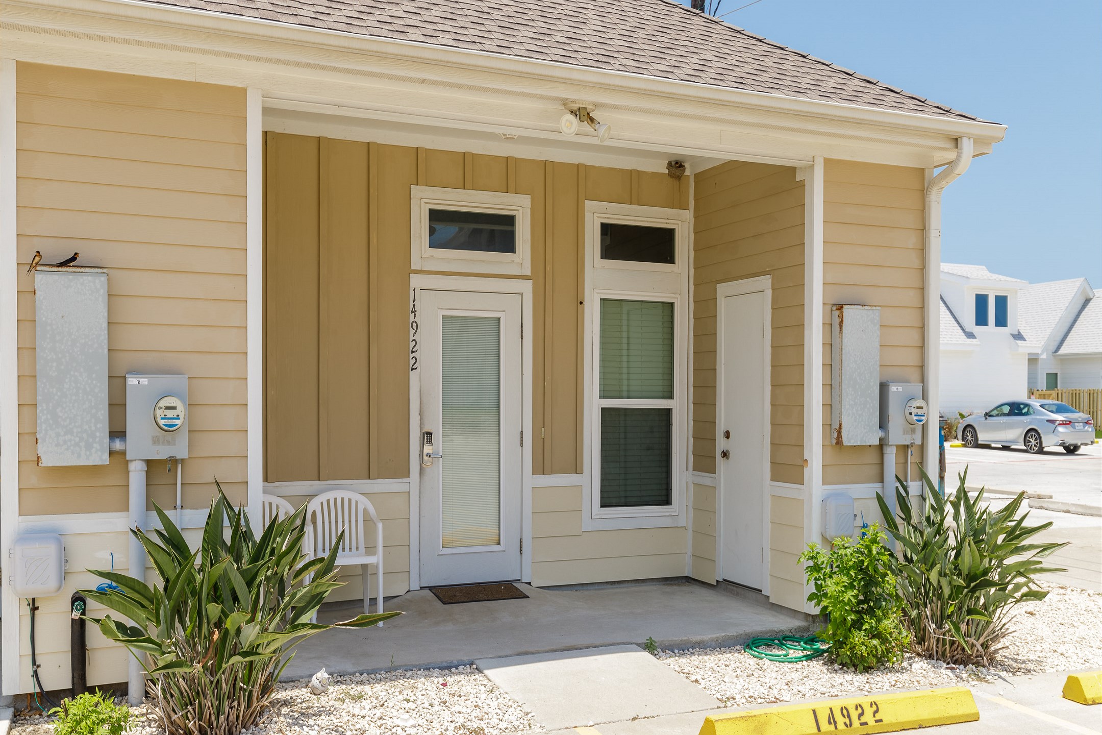Front patio entrance with two reserved parking spaces 