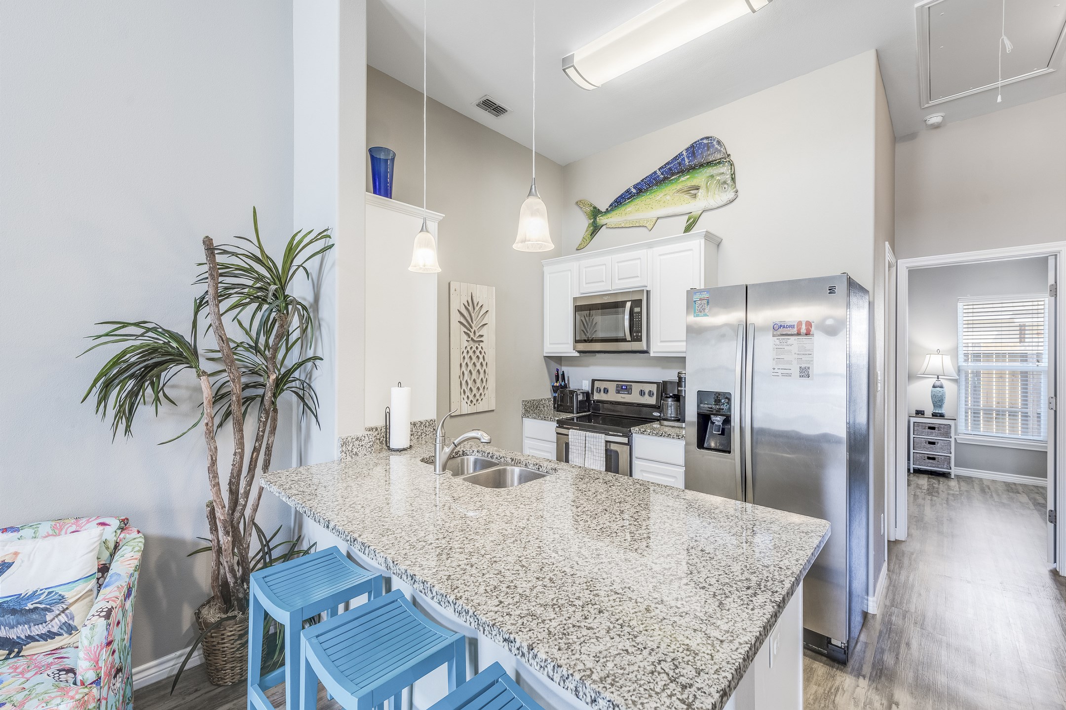Open kitchen with breakfast bar that seats three