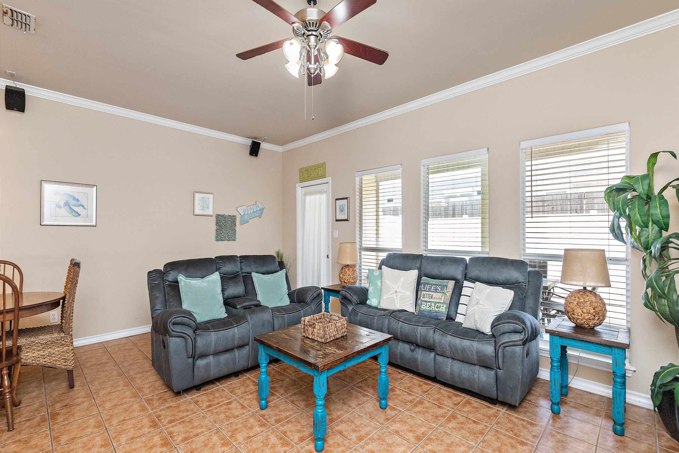 Inviting living space with comfortable furniture, including a queen size sleeper sofa and large windows to allow the light to shine in