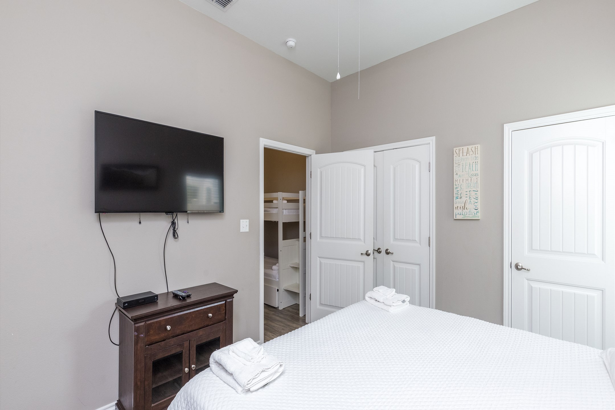 Master bedroom with king size bed and flat screen TV