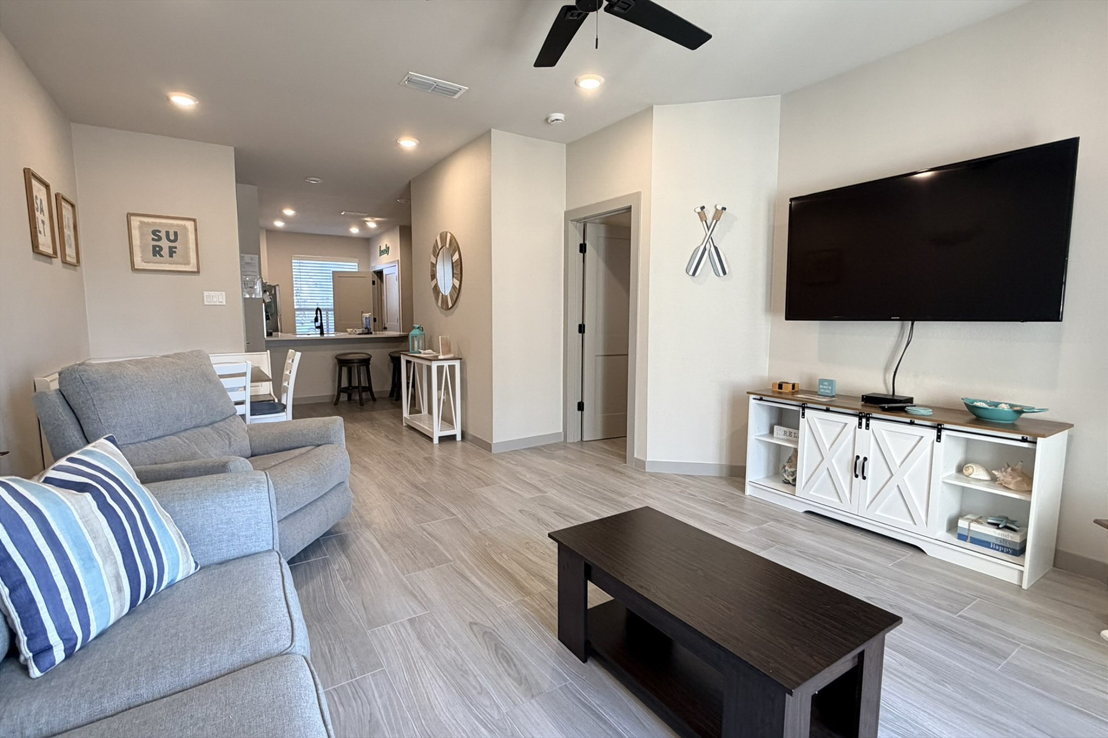 The kitchen, dining, and living areas blend together seamlessly for a bright and airy feel