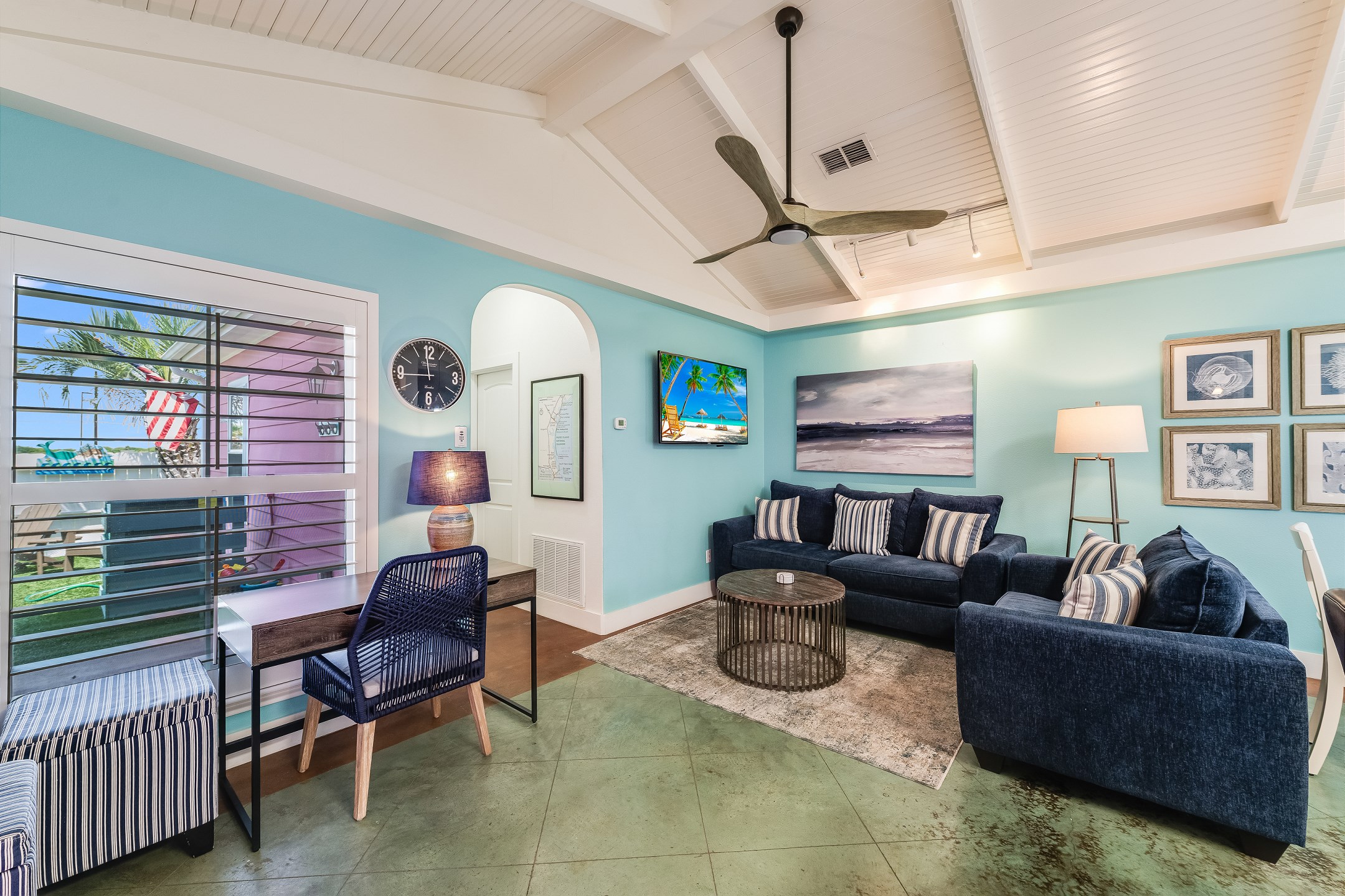 Open concept living area with flat screen TV and desk