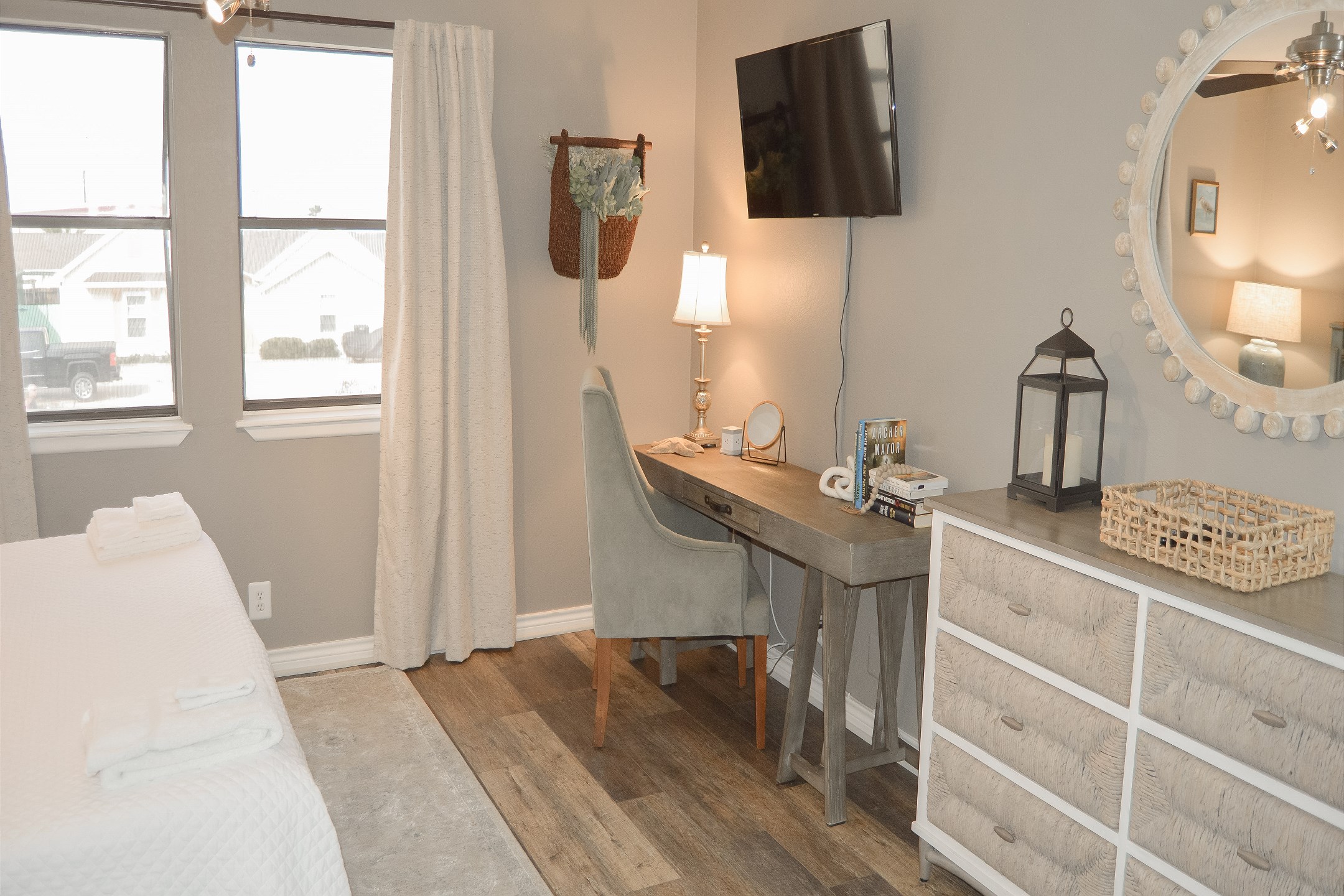 Master bedroom with king size bed, ensuite bathroom, convenient desk area, and flat screen TV