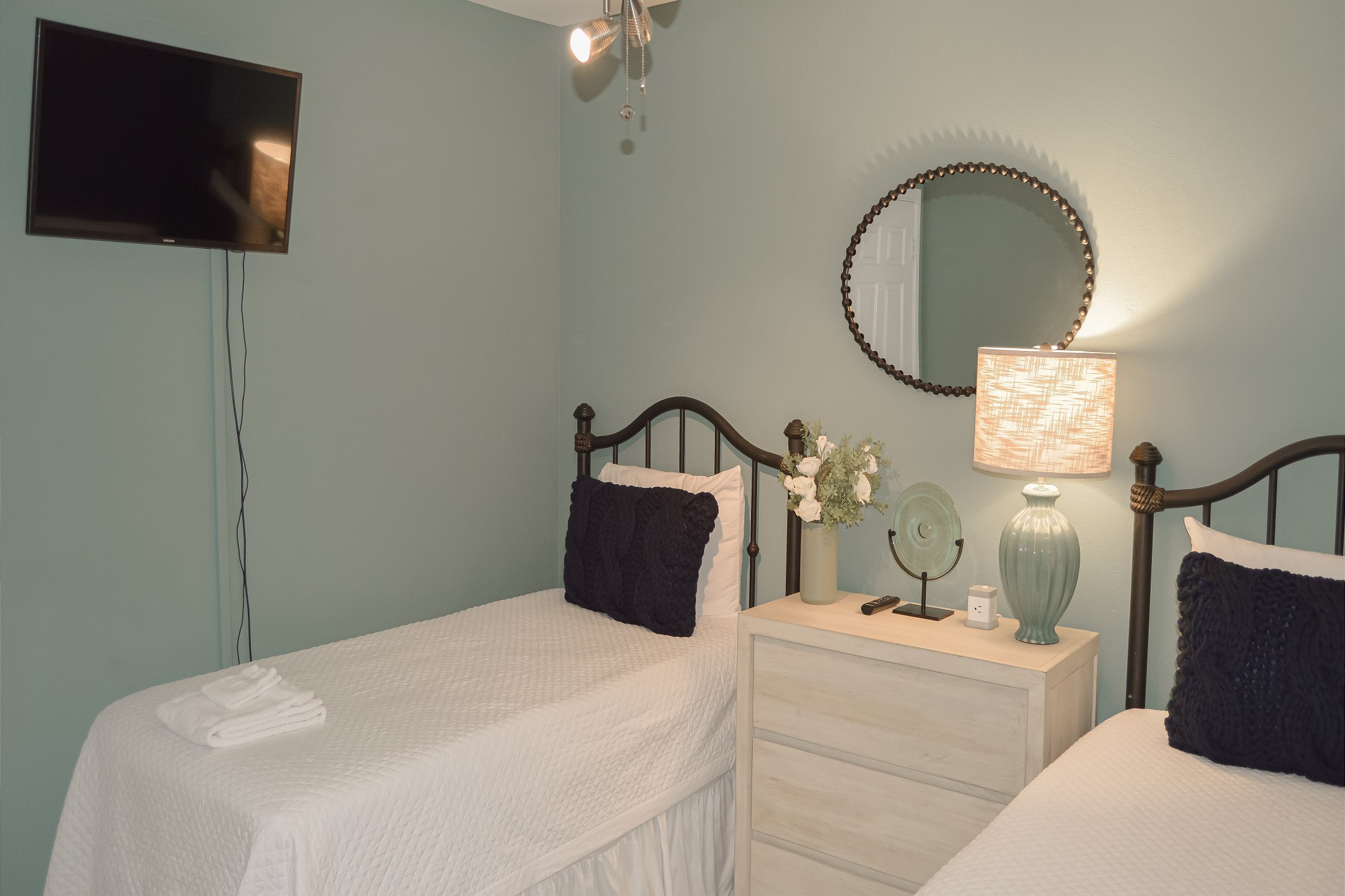 Second bedroom with two twin size beds and flat screen TV