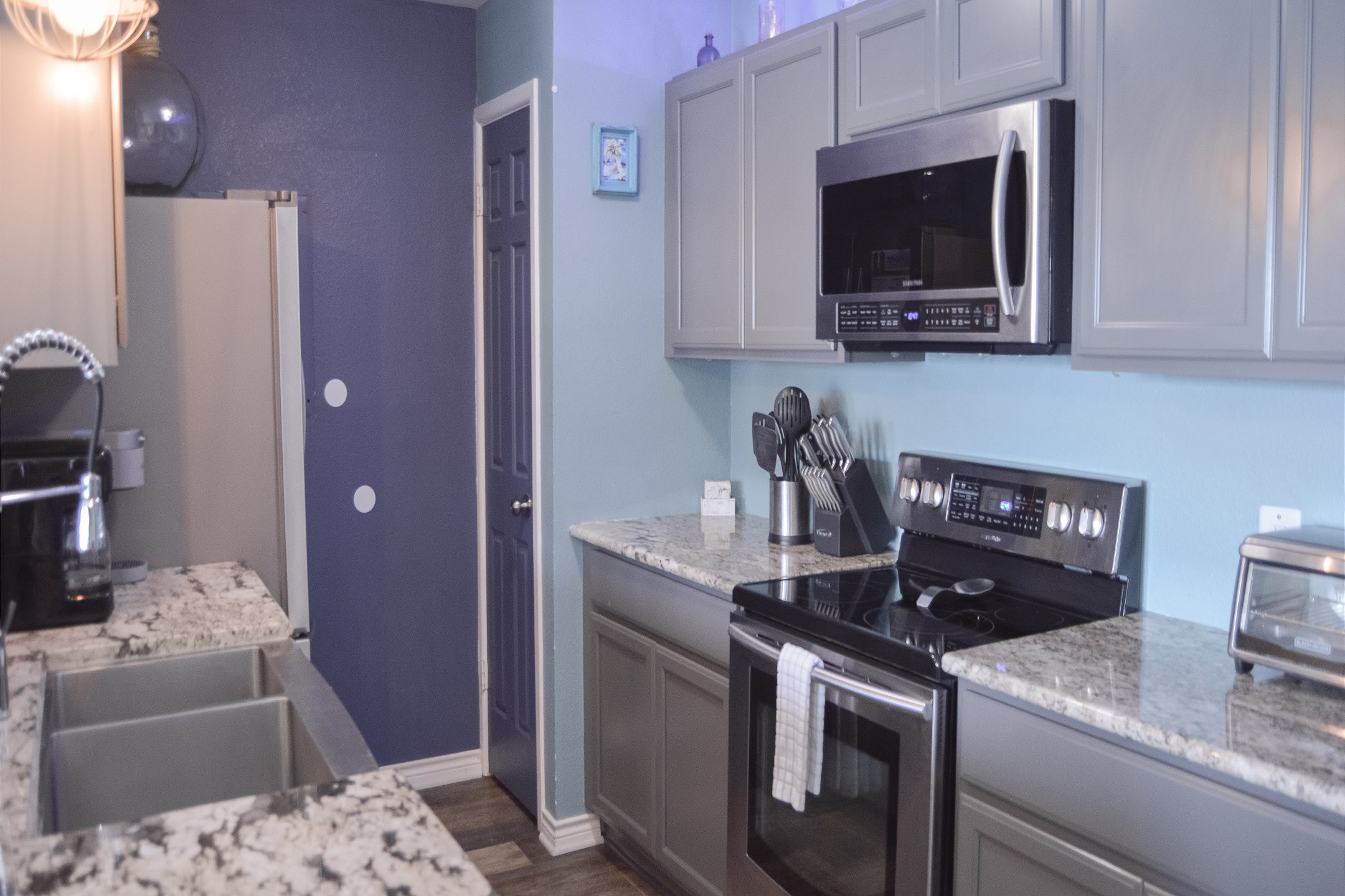 Fully equipped kitchen with stainless steel appliances and beautiful counter tops 