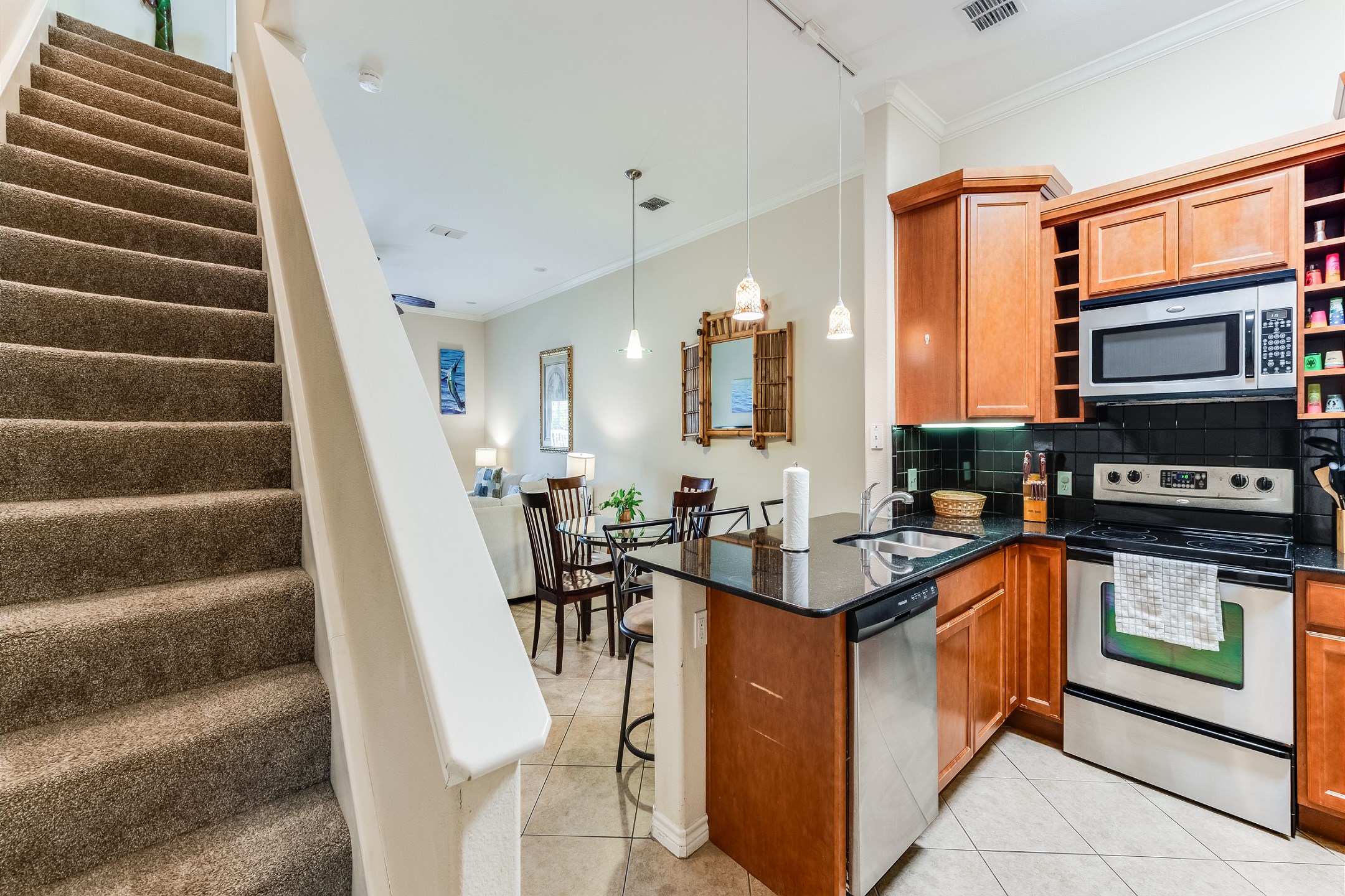 Open concept kitchen and stairs leading to the bedrooms on the second floor 