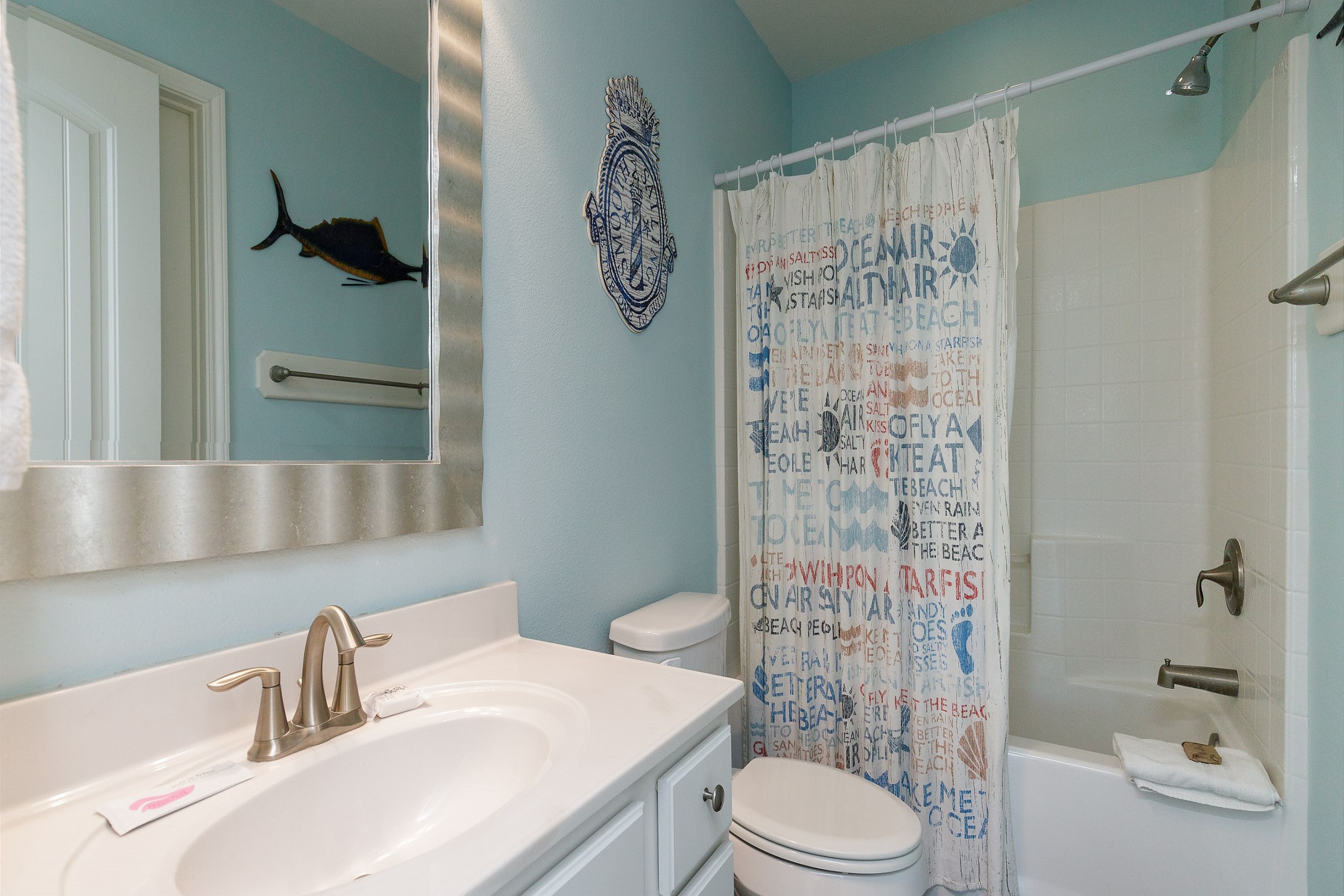 Private bathroom off the second bedroom with tub and shower combo