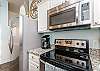Fully equipped kitchen with stainless steel appliances and 12-cup coffee maker 