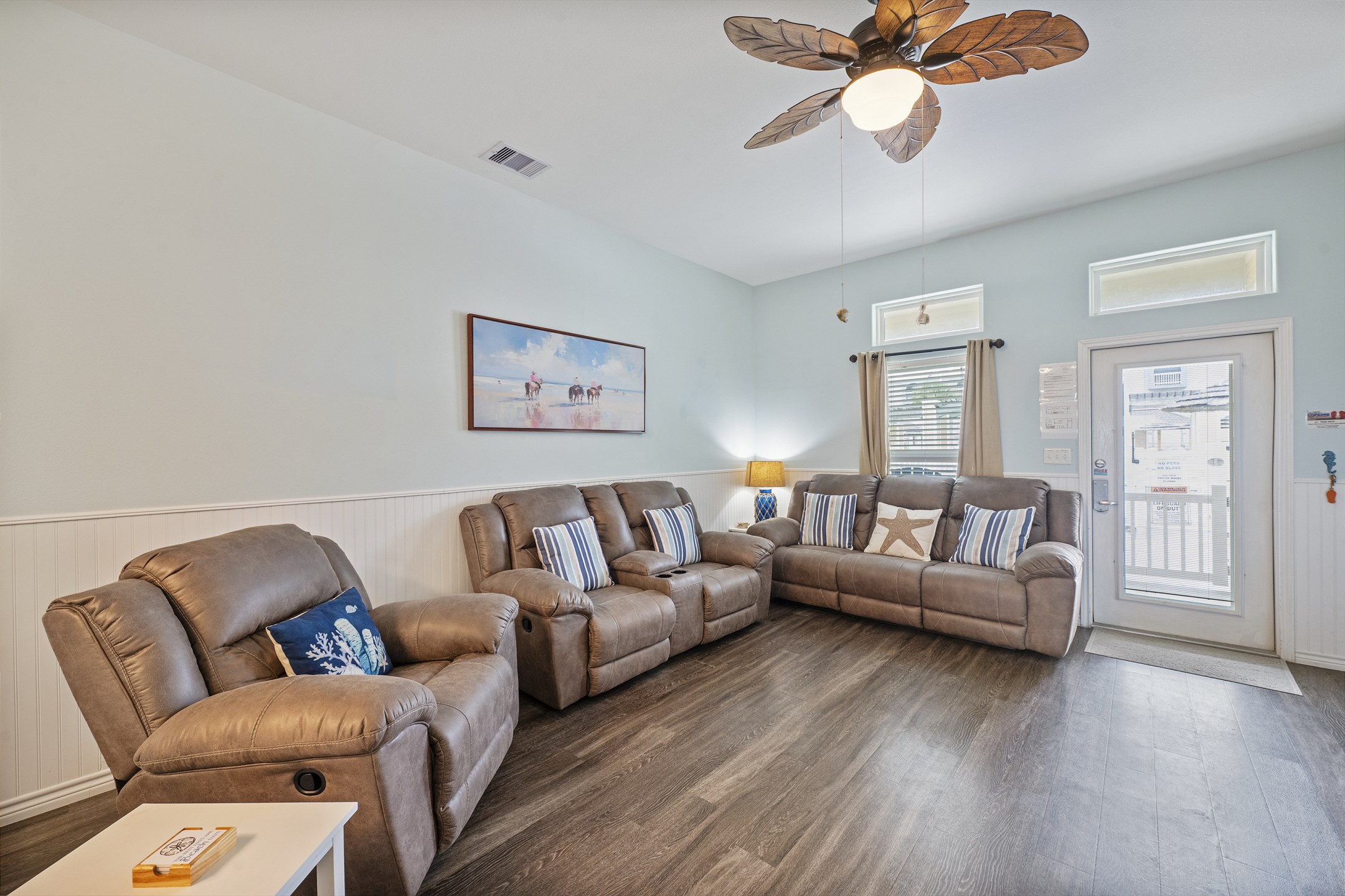 Open-concept living area with high ceilings, flooded with natural light 