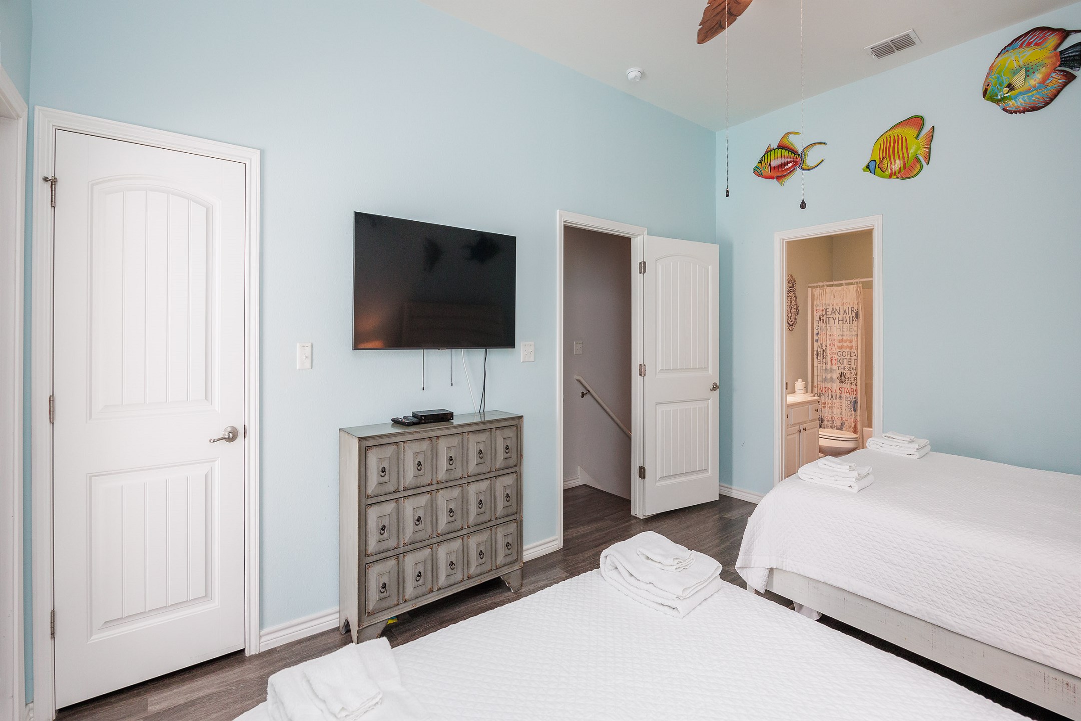 Second bedroom on the second floor with two queen size beds, private balcony, private bathroom and flat screen TV