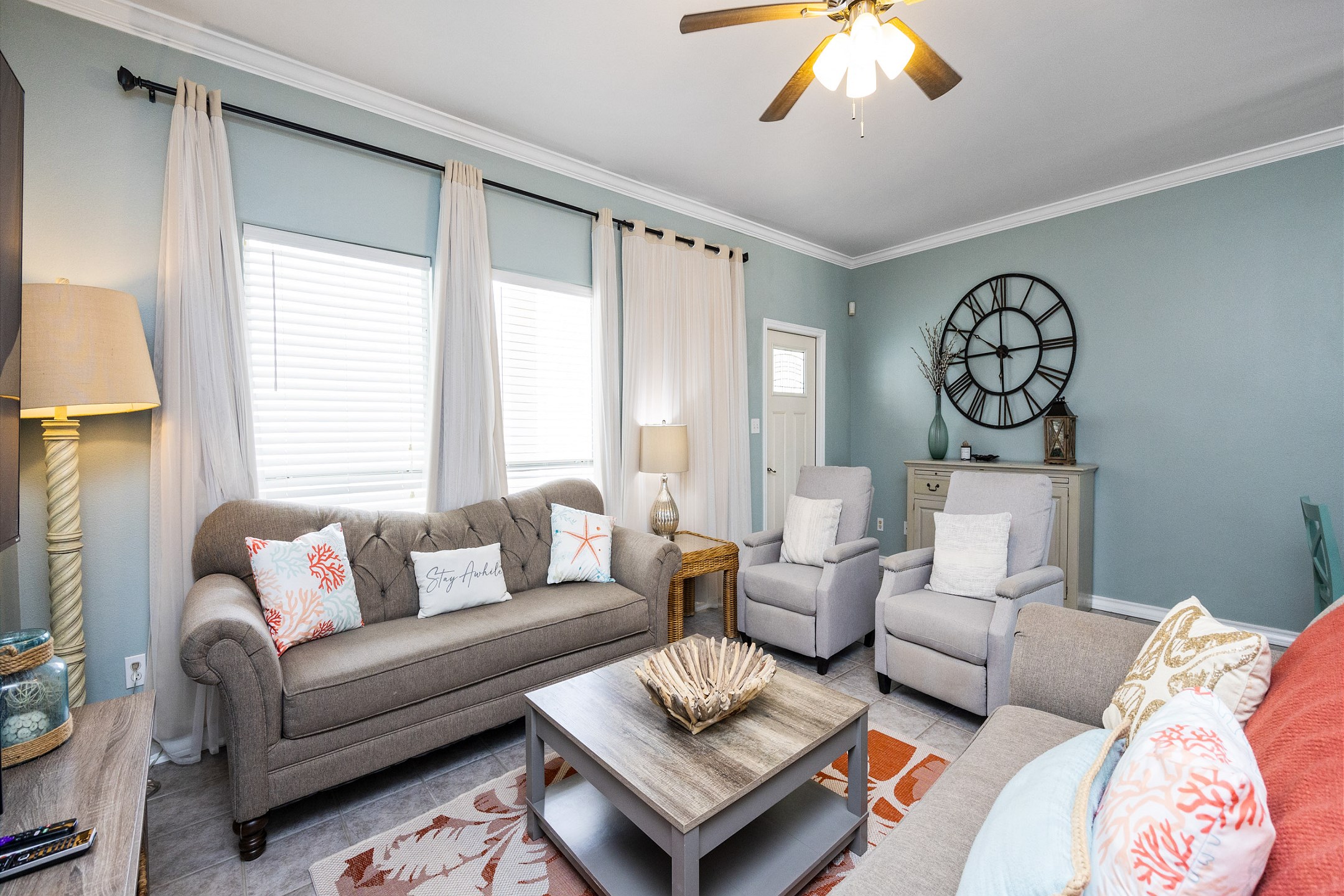 Living space with access to the private patio and large windows with natural light shinning through