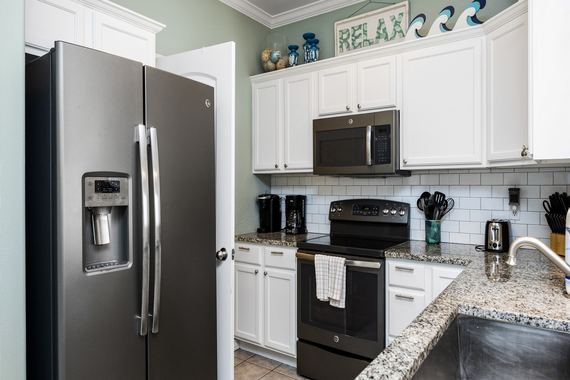 Large kitchen space with updated appliances and beautiful counter tops 