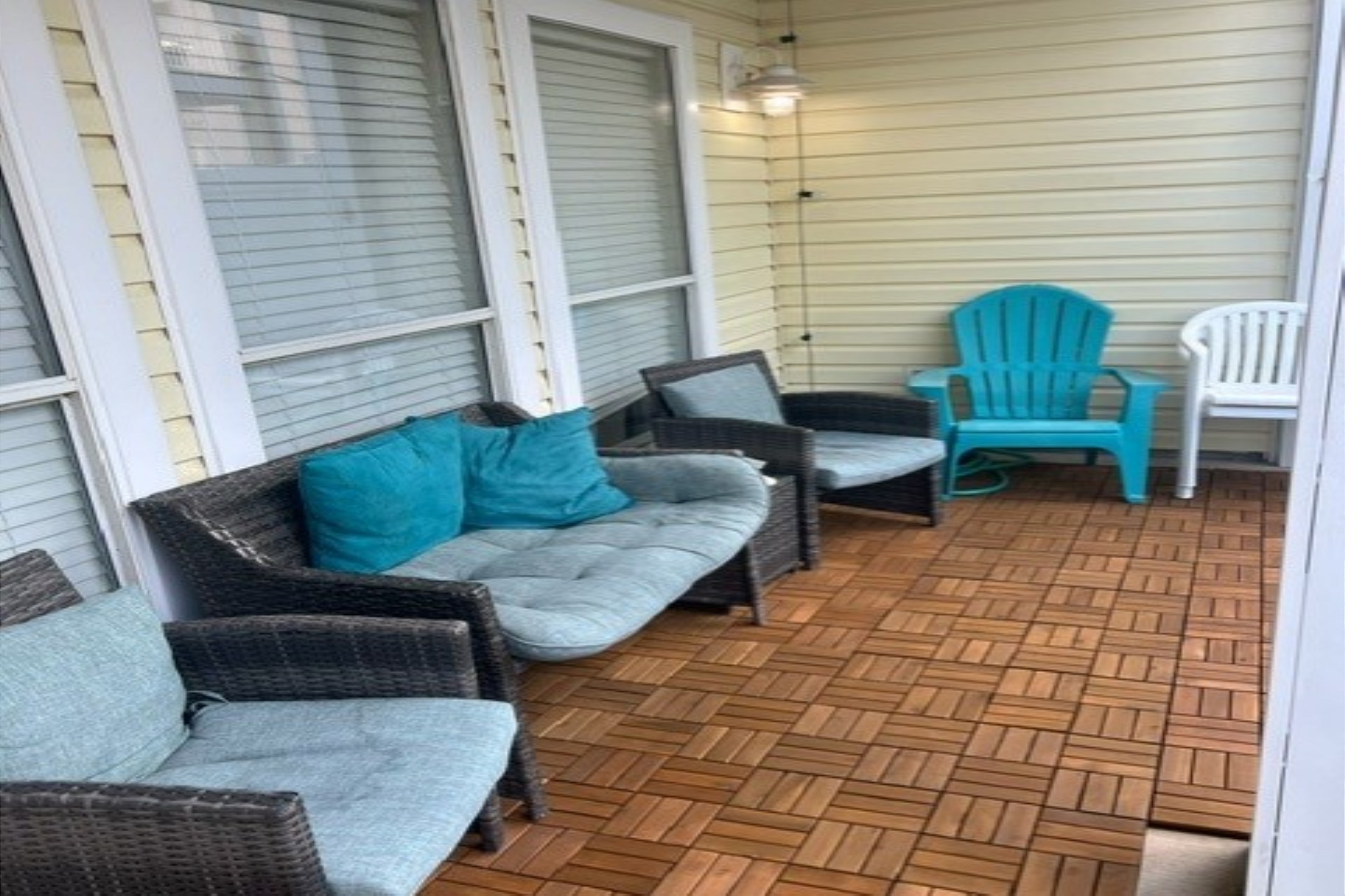 Back yard area with comfortable seating and artificial turf 