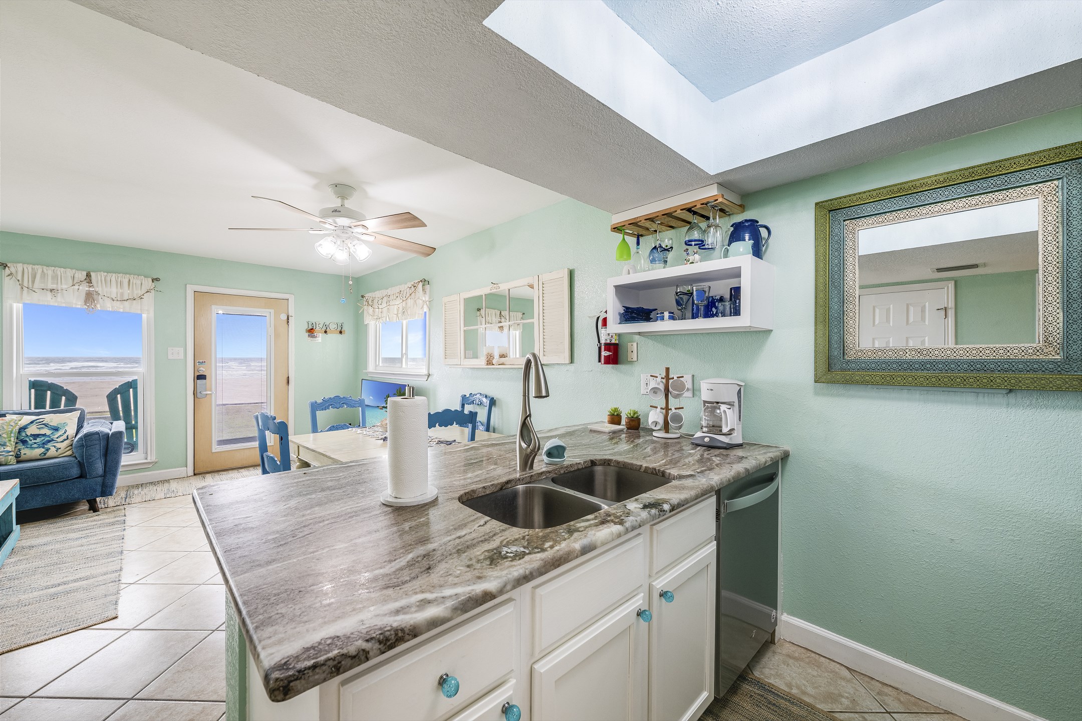 Open kitchen layout with plenty of counter space and coastal charm